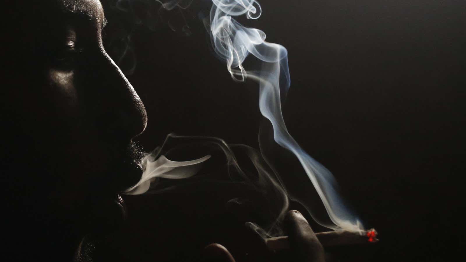 A heroin addict smokes heroin in Lamu, Kenya