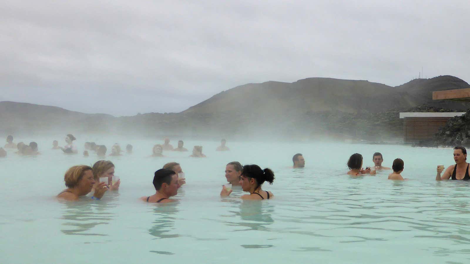 Visitors enjoy a drink in the Blue Lagoon geothermal spa in Grindavik, Iceland, May 25, 2016.
