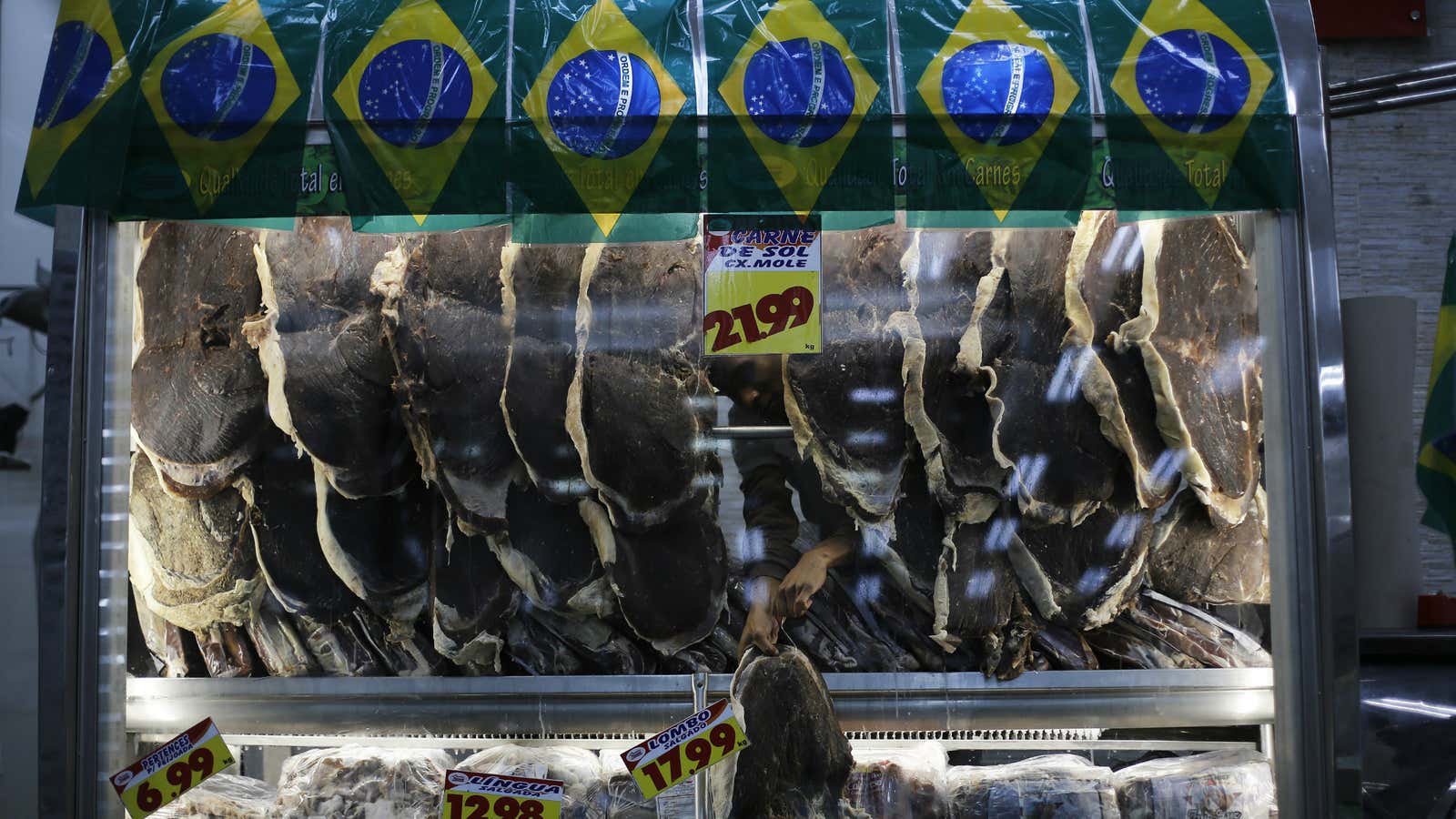 A vendor sells meat in Sao Paulo.