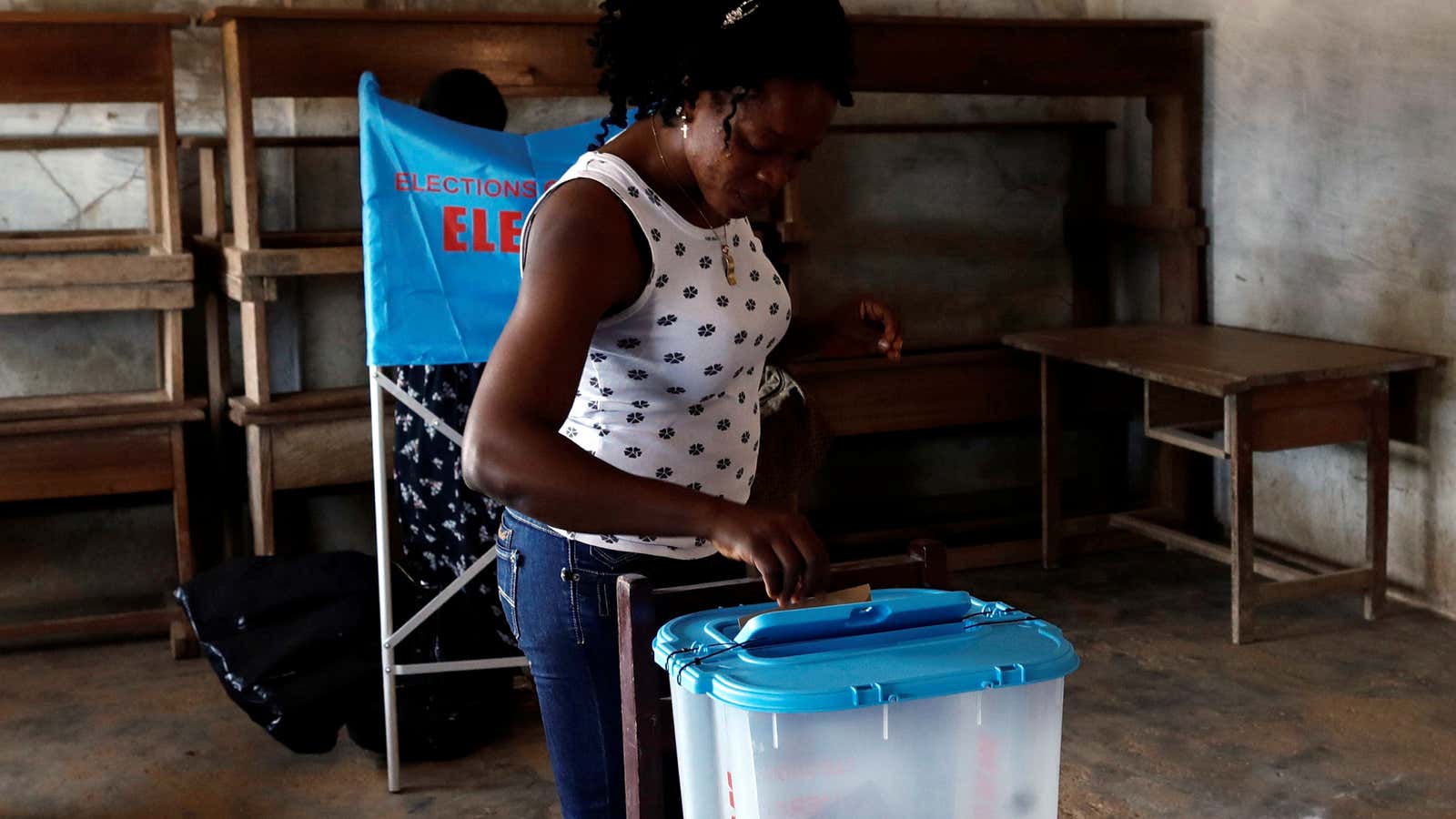 A woman casts her ballot at a polling station during the presidential election, in Yaounde, Cameroon