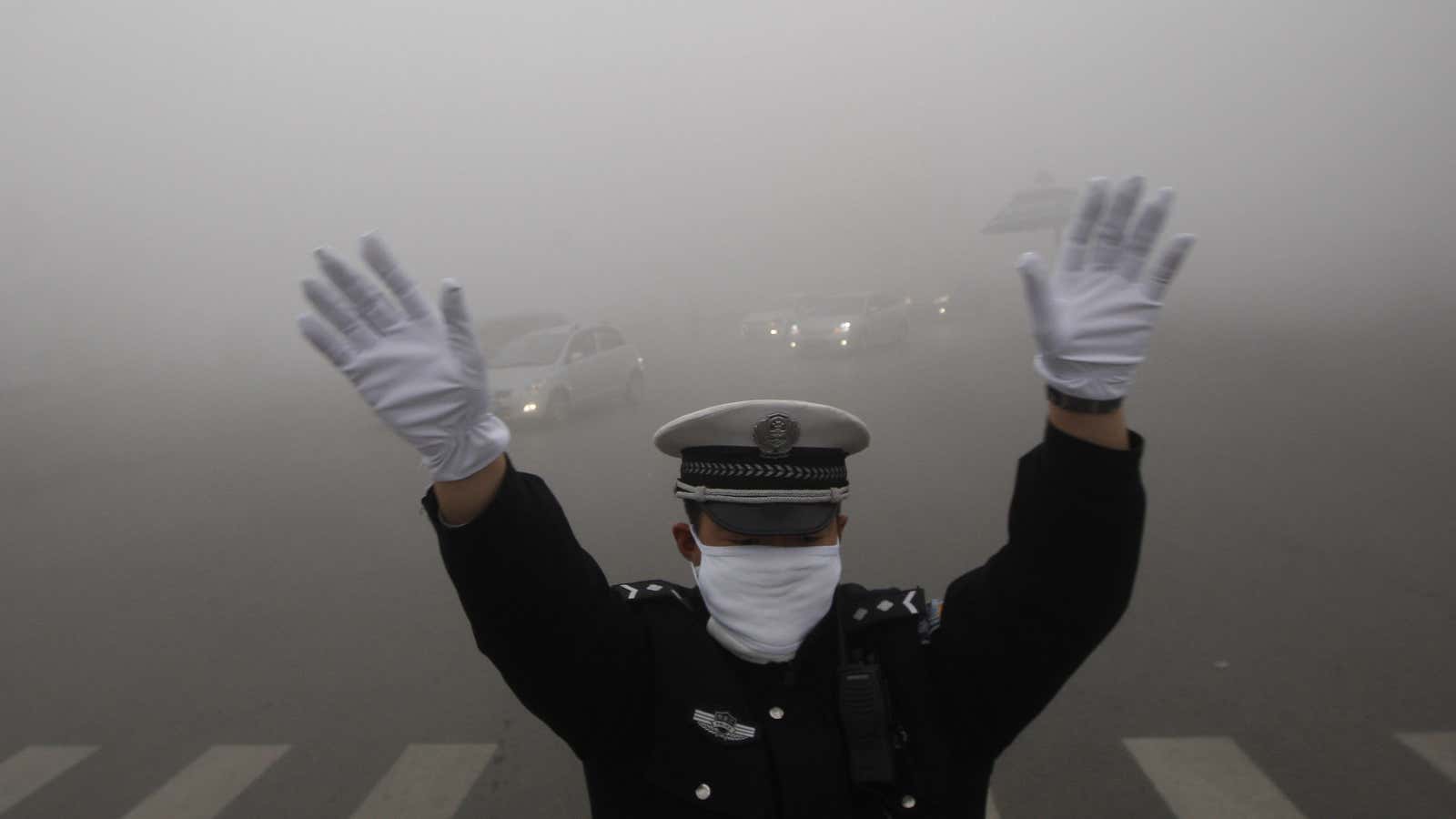 A traffic cop braves Harbin’s haze.