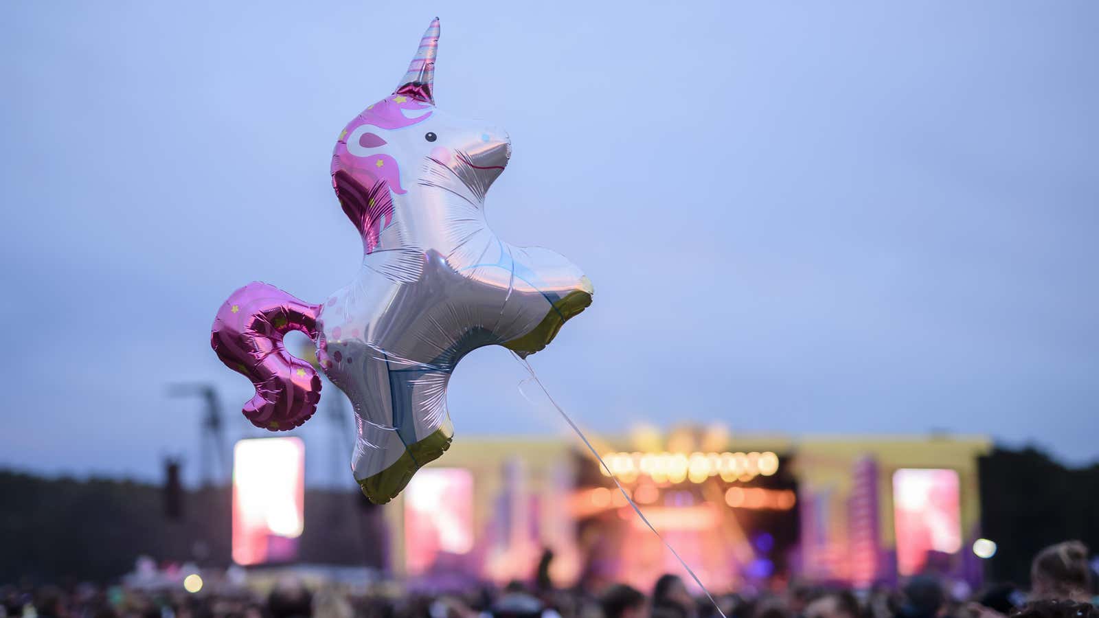 Mandatory Credit: Photo by Clemens Bilan/EPA-EFE/REX/Shutterstock (9048361ck) A visitor holds a balloon in the shape of a unicorn at the Lollapalooza Festival in Hoppegarten near…