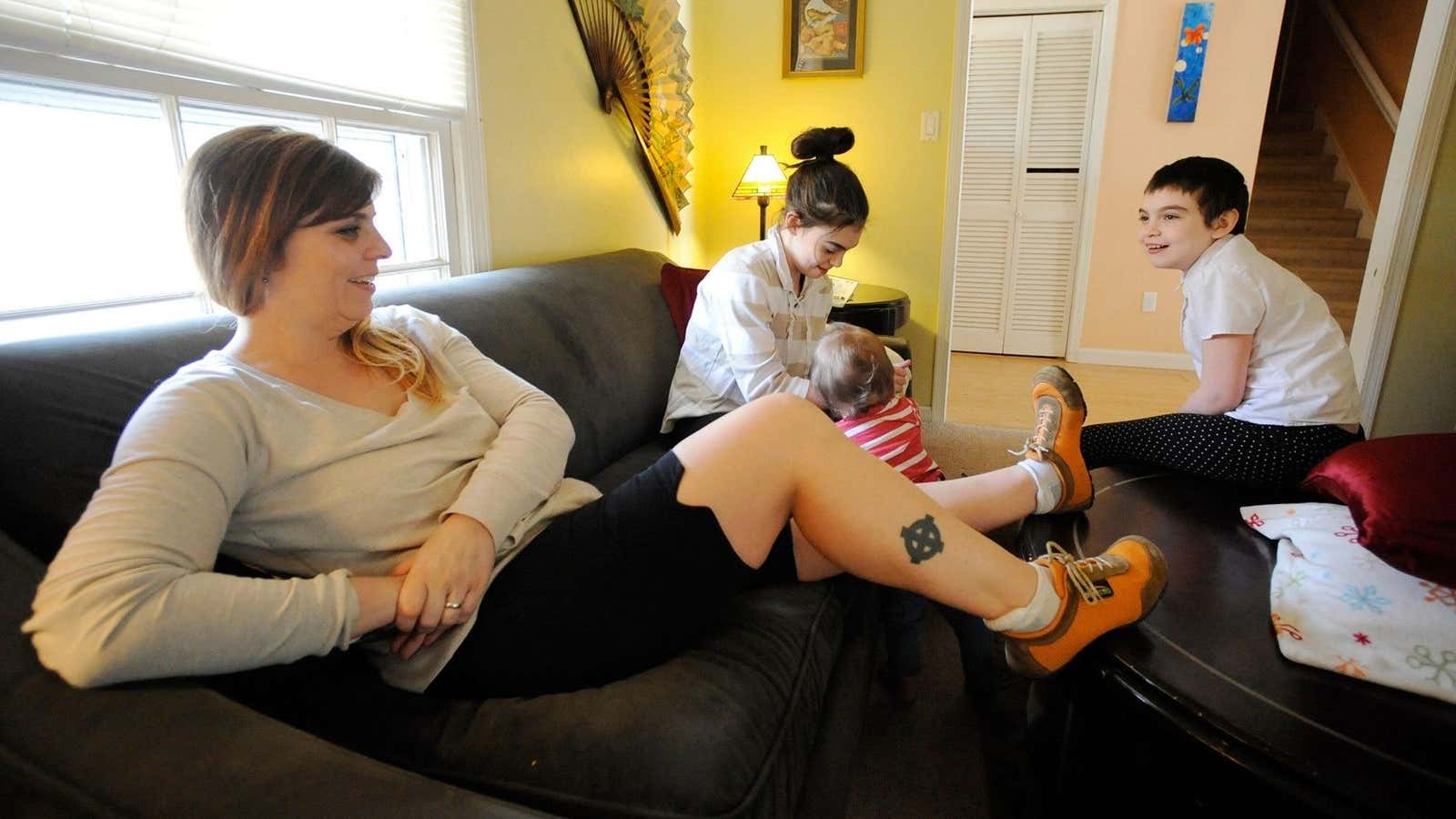 Former neo-Nazi Shannon Martinez plays with two of her children at home.
