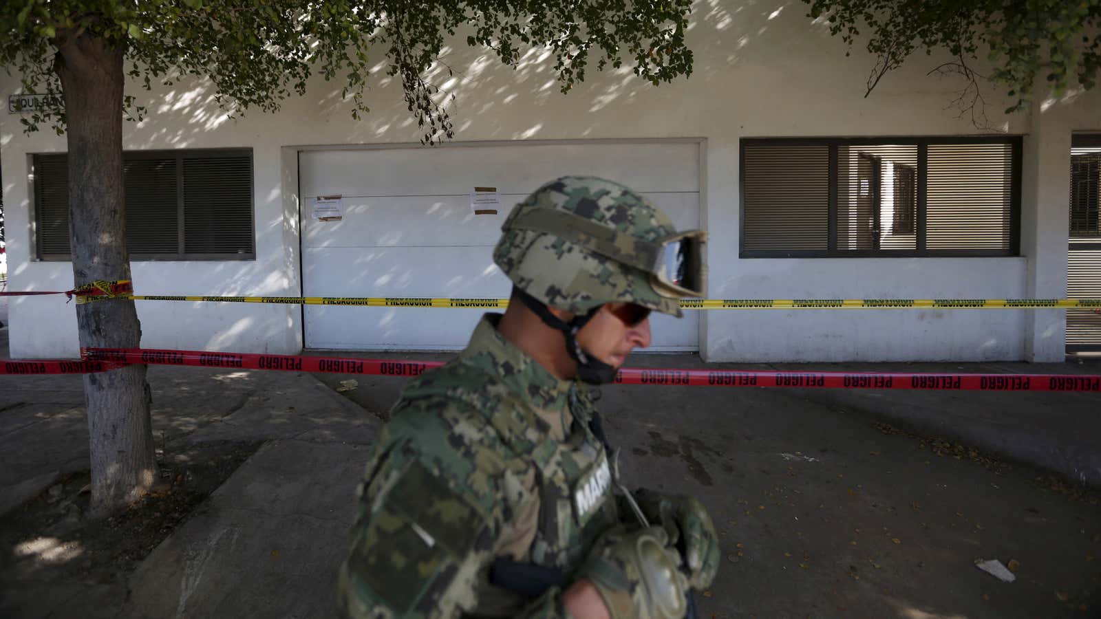 A soldier keeps watch outside the house where five people were shot dead during an operation to recapture the world’s top drug lord Joaquin “El Chapo” Guzman earlier this month.