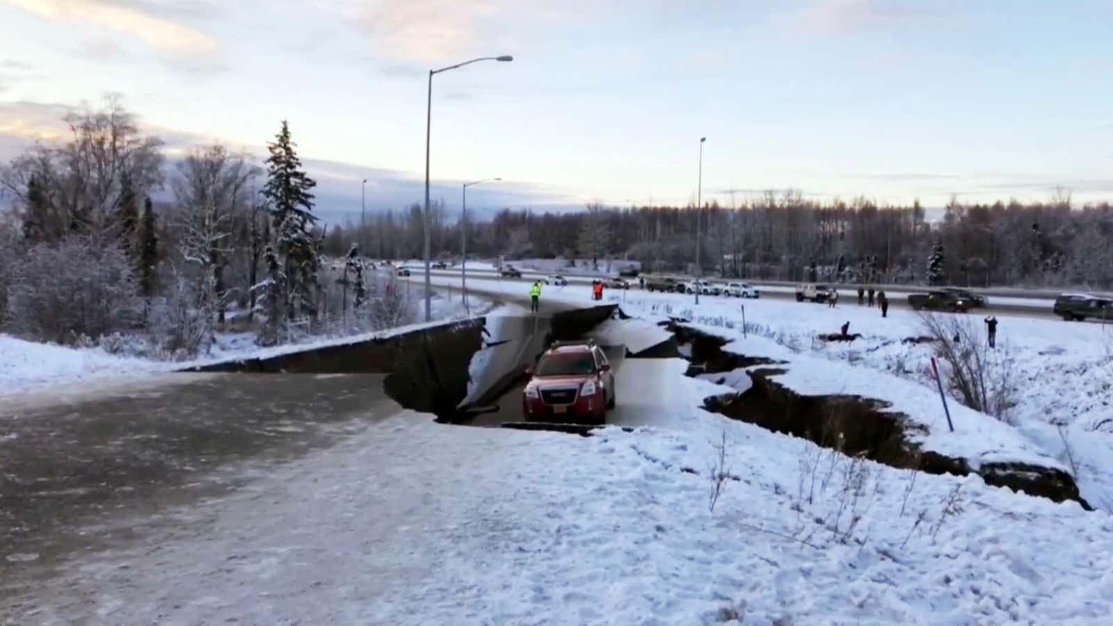 A car is trapped on a collapsed section of the offramp in Anchorage, Friday, Nov. 30, 2018. Back-to-back earthquakes measuring 7.0 and 5.8 rocked buildings and buckled roads Friday morning in Anchorage, prompting people to run from their offices or seek shelter under office desks, while a tsunami warning had some seeking higher ground. (AP Photo
