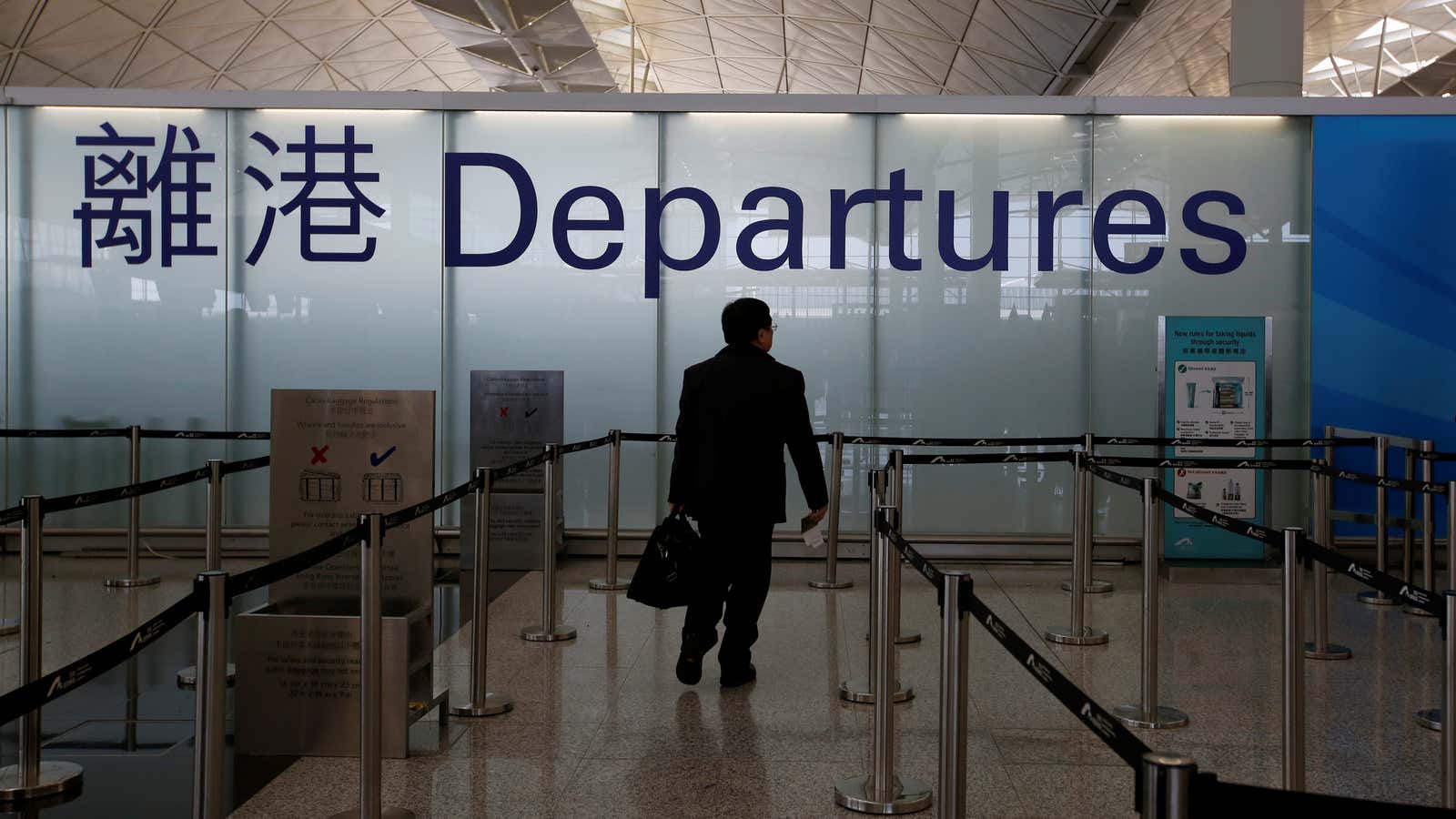 A passenger walks into the departure immigration counter at Hong Kong International Airport in Hong Kong, China January 11, 2018. REUTERS/Bobby Yip