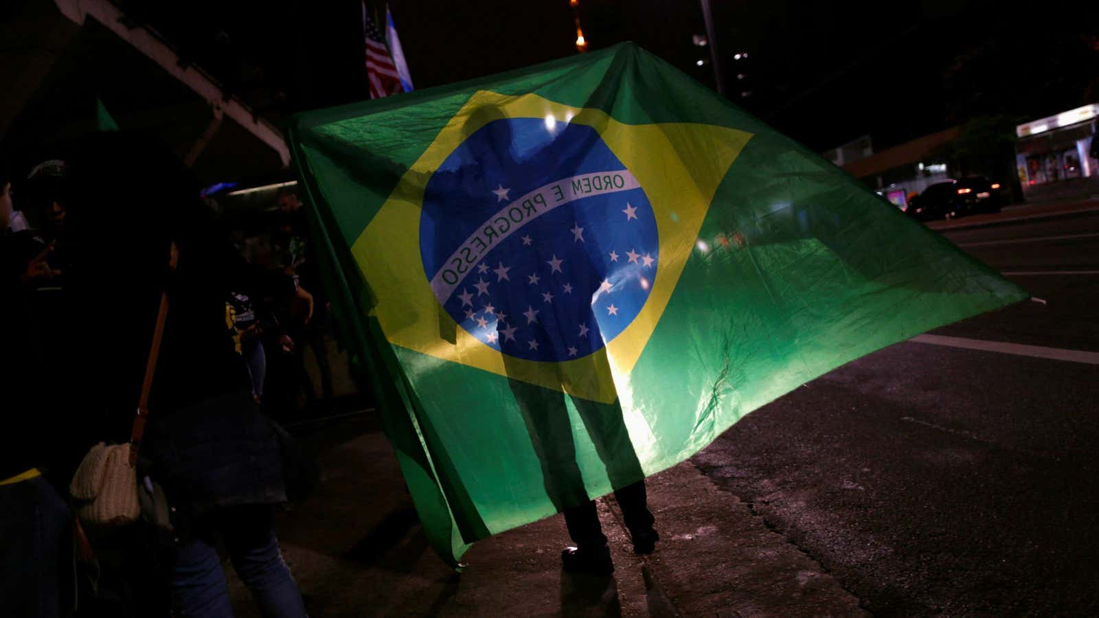 A man waves the Brazilian flag on election day in São Paulo.