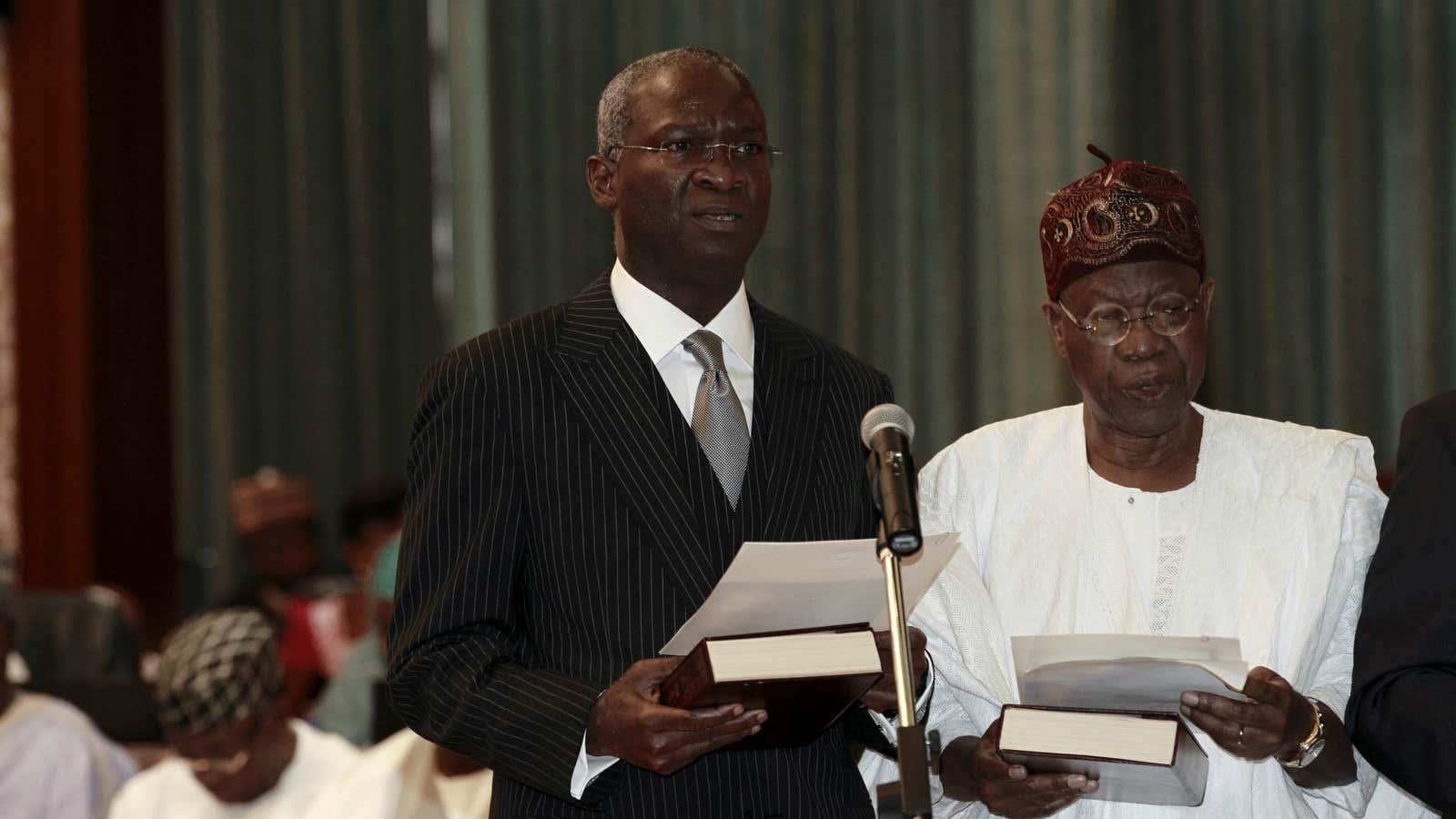 Nigeria’s new Power, Works and Housing Minister Babatunde Fashola (front L) and new Information Minister Lai Mohammed take their oath of office