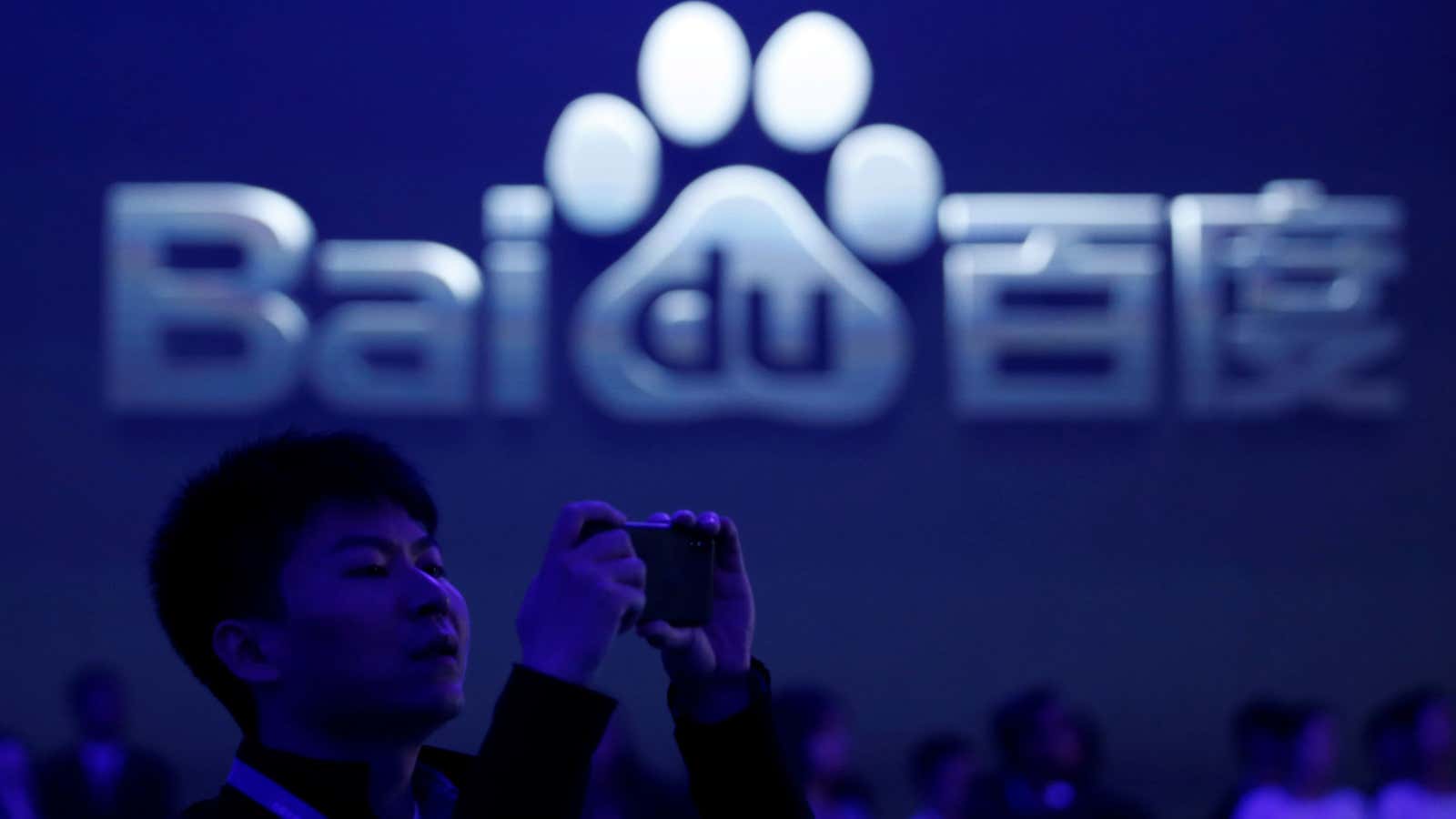 A man takes pictures at the 2018 Baidu World conference and exhibit in Beijing, China, November 1, 2018. REUTERS/Jason Lee – RC1951988F50