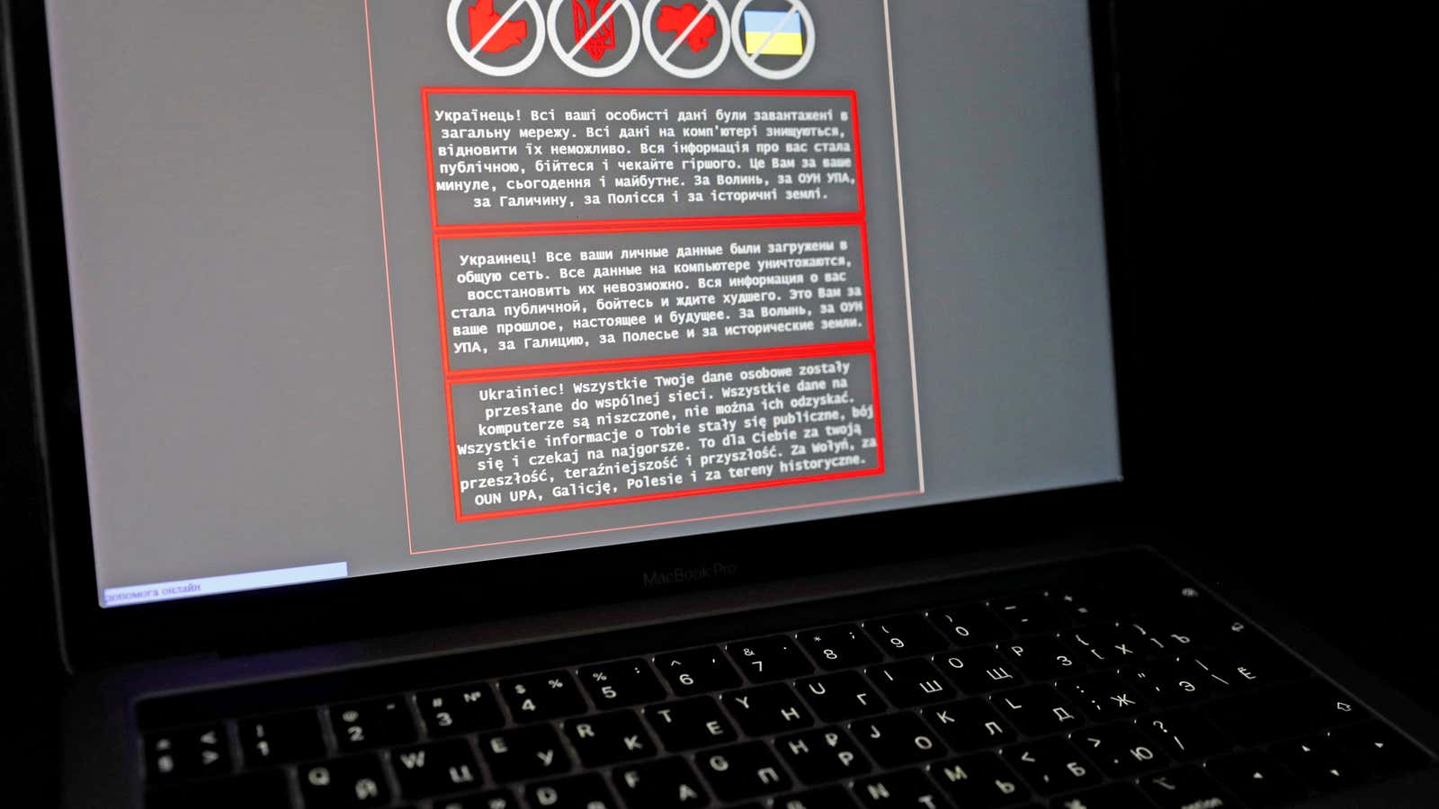 A laptop screen displays a warning message in Ukrainian, Russian and Polish, that appeared on the official website of the Ukrainian Foreign Ministry after a…