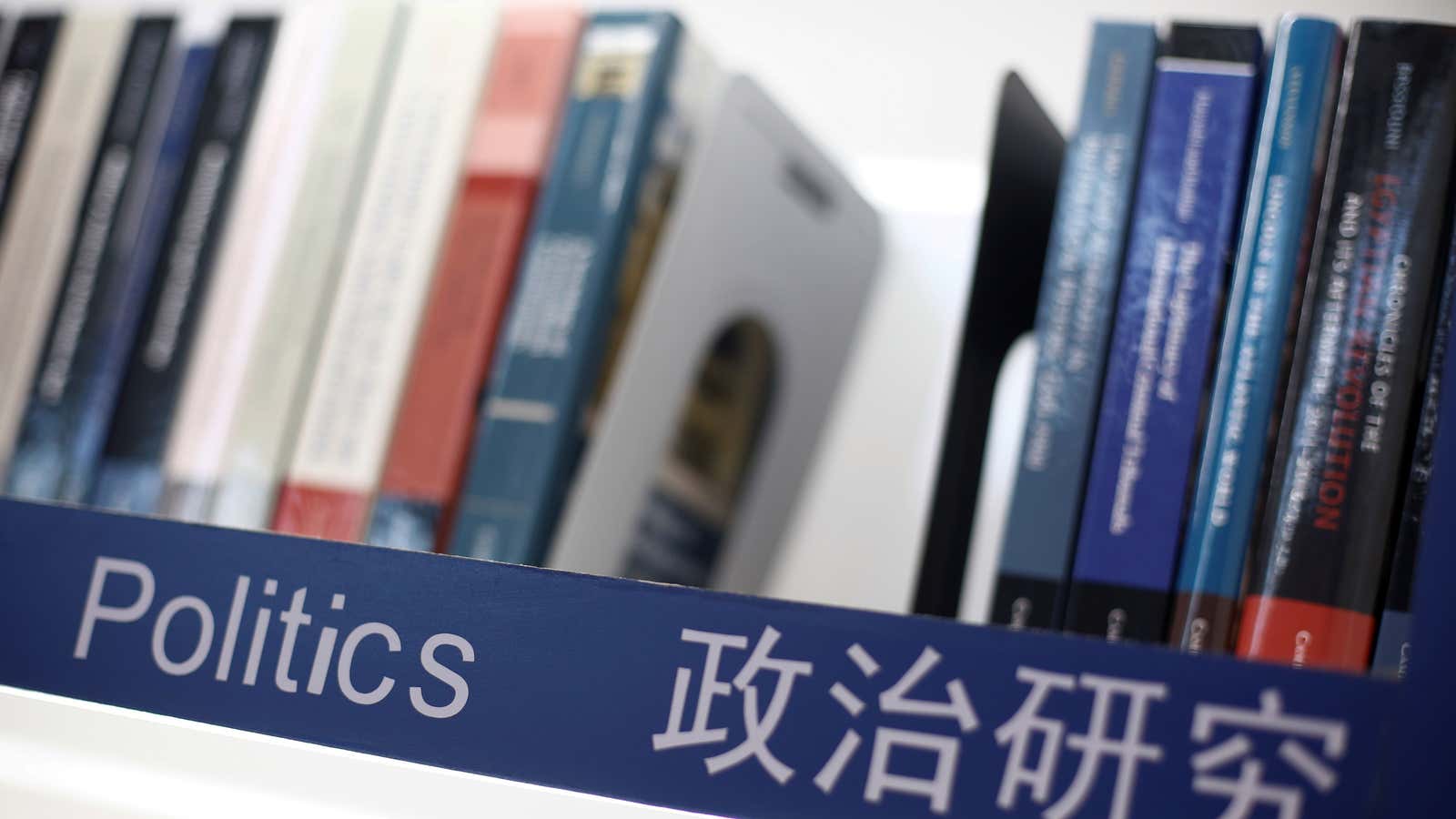 Books on politics are seen on a shelf at the Cambridge University Press (CUP) stall at the Beijing International Book Fair in Beijing, China, August…