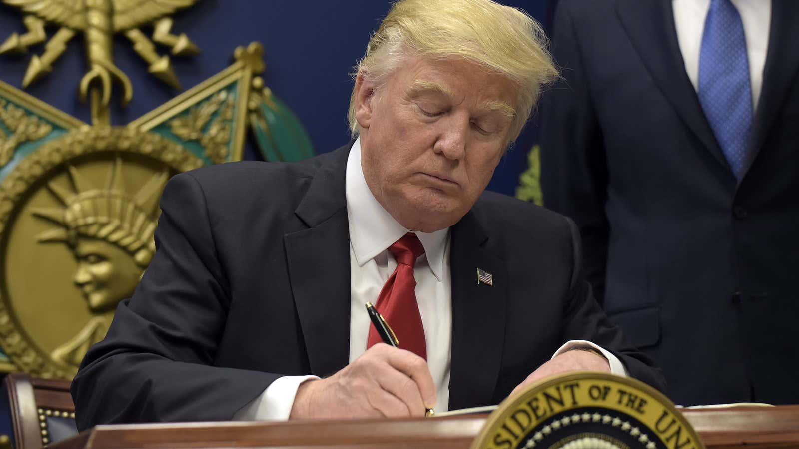 Trump signing the order.