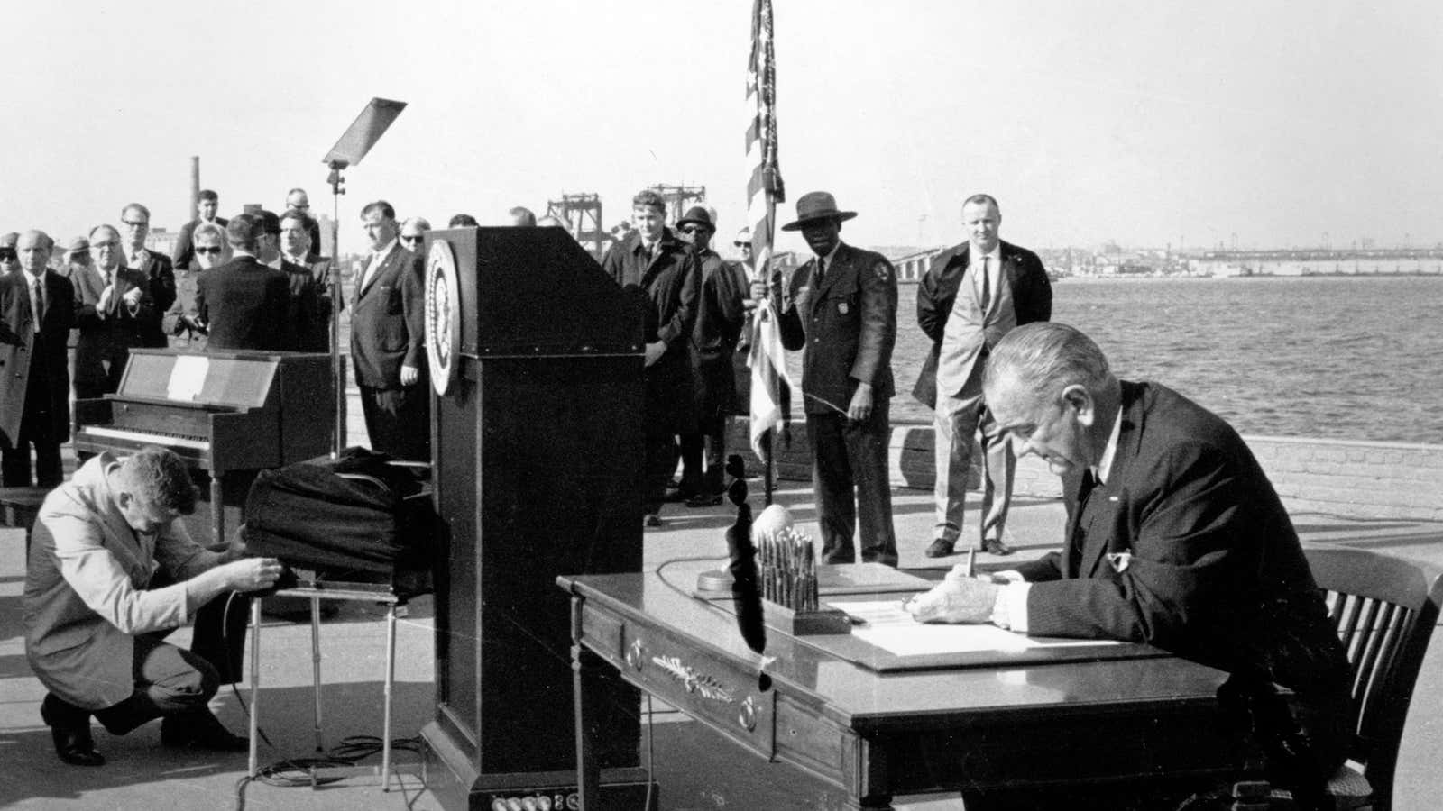President Johnson signs the 1965 immigration law in New York Harbor.