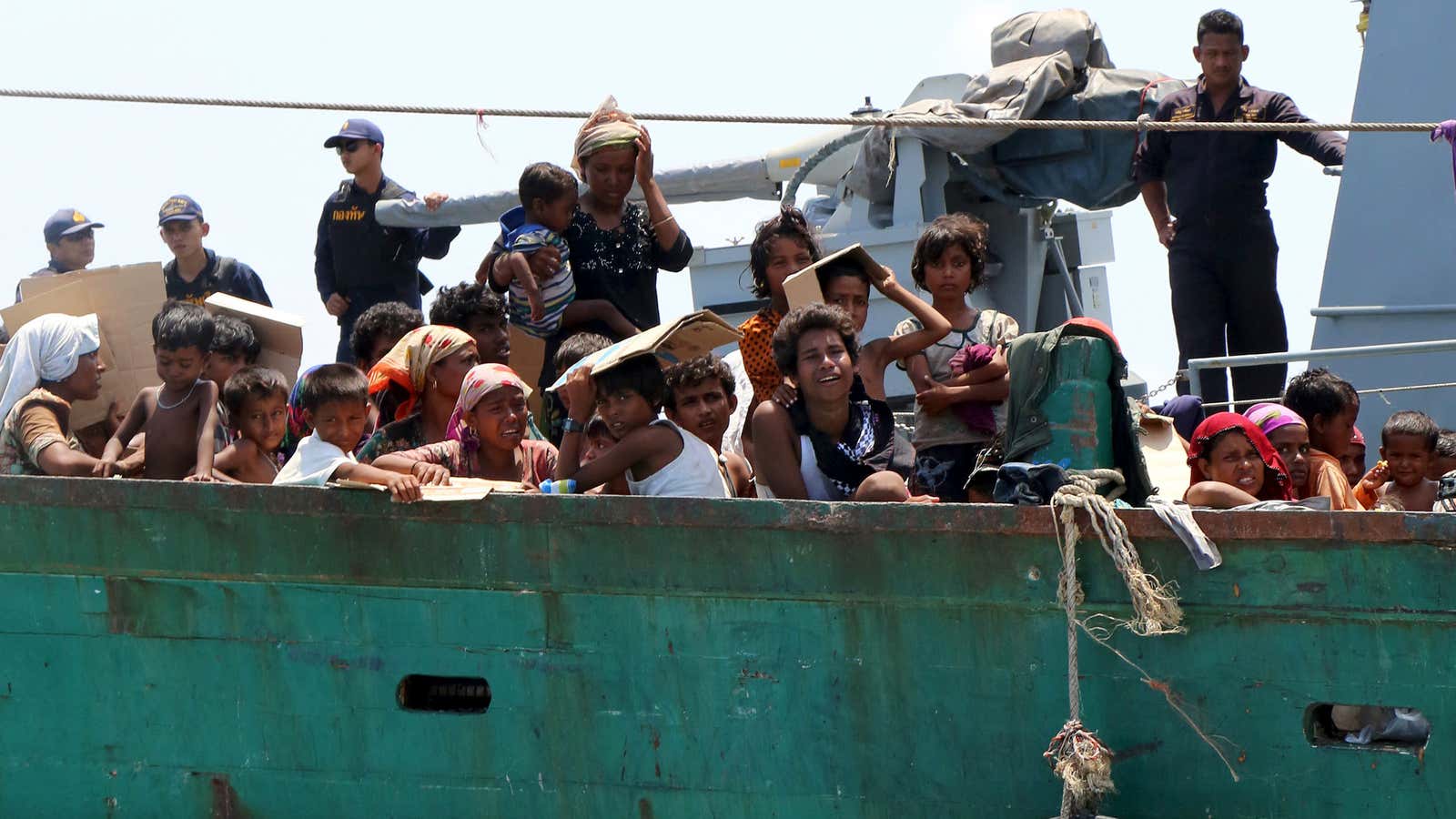 The Thai Navy pushes a drifting boat full of refugees away from its shores.