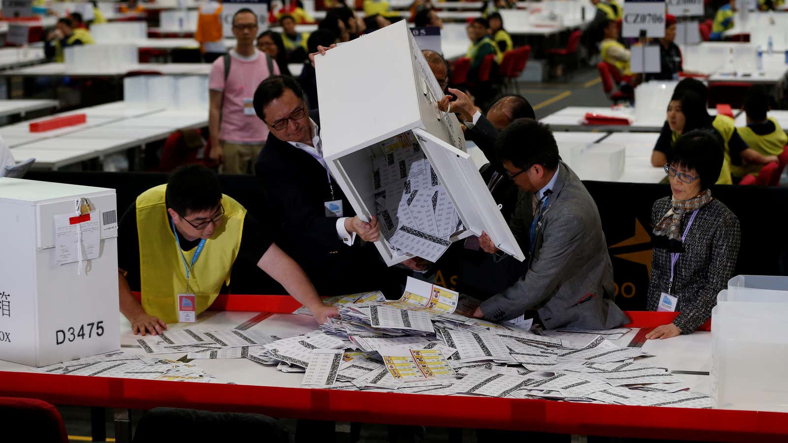 Electoral officers empty a ballot box at a vote counting center in Hong Kong, September 5, 2016.