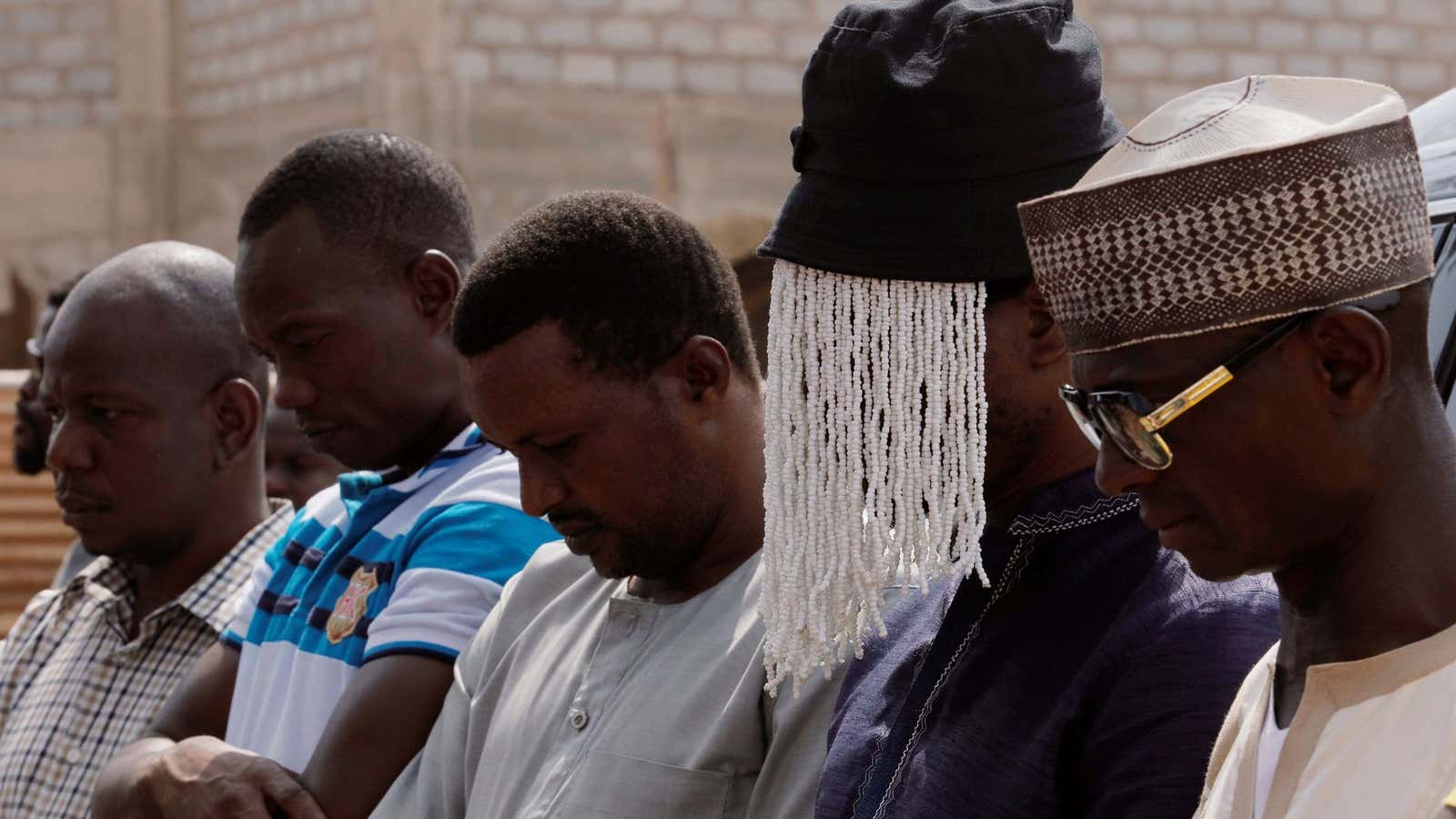 Undercover journalist Anas Aremeyaw Anas prays with others for his slain colleague Ahmed Hussein-Suale, an investigative journalist who was killed by gunmen on Wednesday, at Madina Central Mosque in Accra, Ghana Jan.18, 2019.