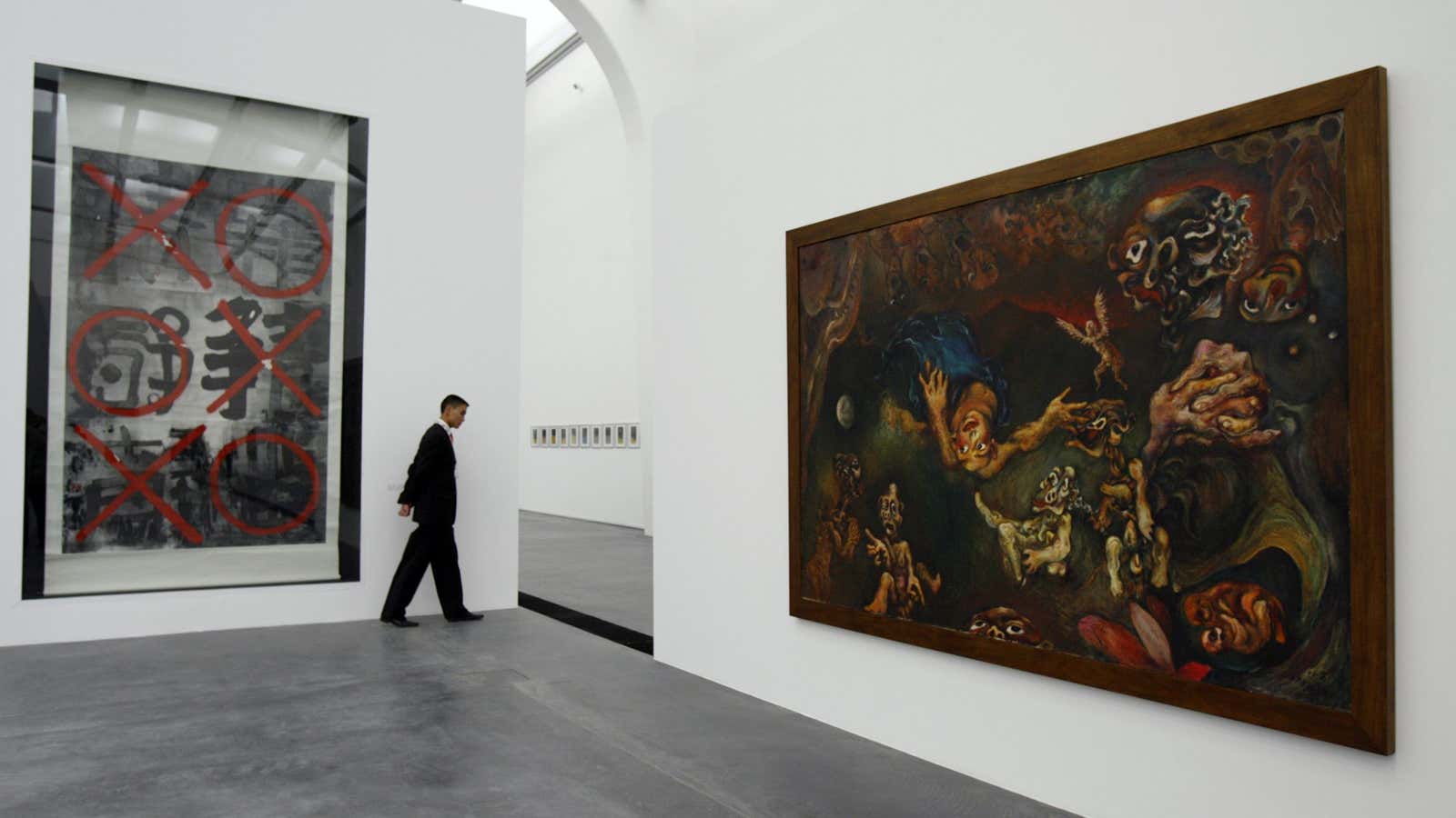 A visitor walks past works of Chinese artists displayed at Ullens Center for Contemporary Art (UCCA).