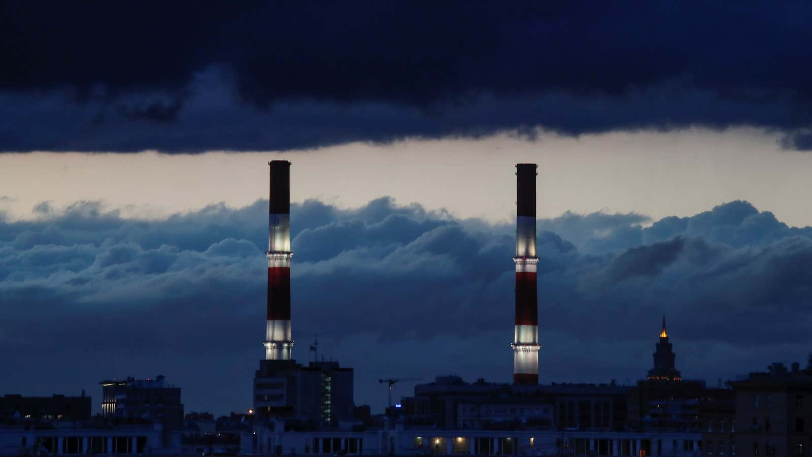Chimneys of a heating power plant are pictured on a stormy evening in Moscow, Russia, April 21, 2018. REUTERS/Maxim Shemetov – RC1BEC042D40