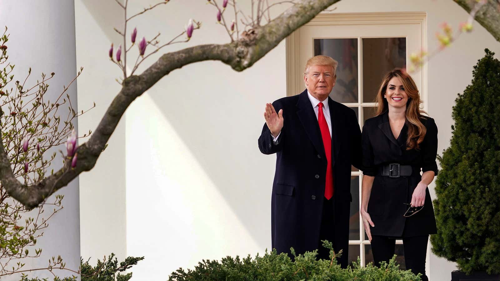 President Donald Trump waves with outgoing White House Communications Director Hope Hicks