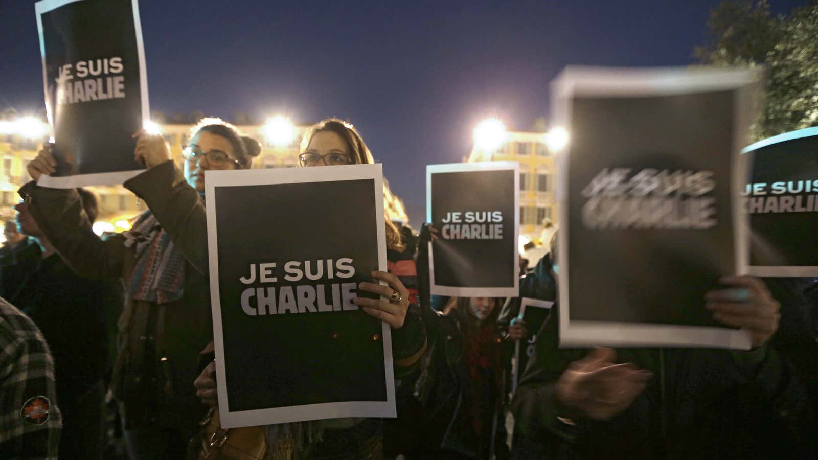 People hold posters reading ‘I am Charlie’ as they gather to express solidarity with those killed in an attack at the Paris offices of weekly newspaper Charlie Hebdo.