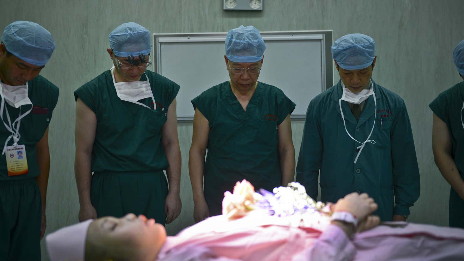 Chinese officials make a silent tribute to a deceased patient who donated her organs at a hospital in Guangzhou in 2012.