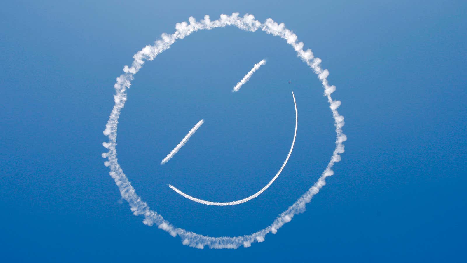 A sky writer draws a smiley face in the sky at the start of the Los Angeles County Air Show at the General William J.…