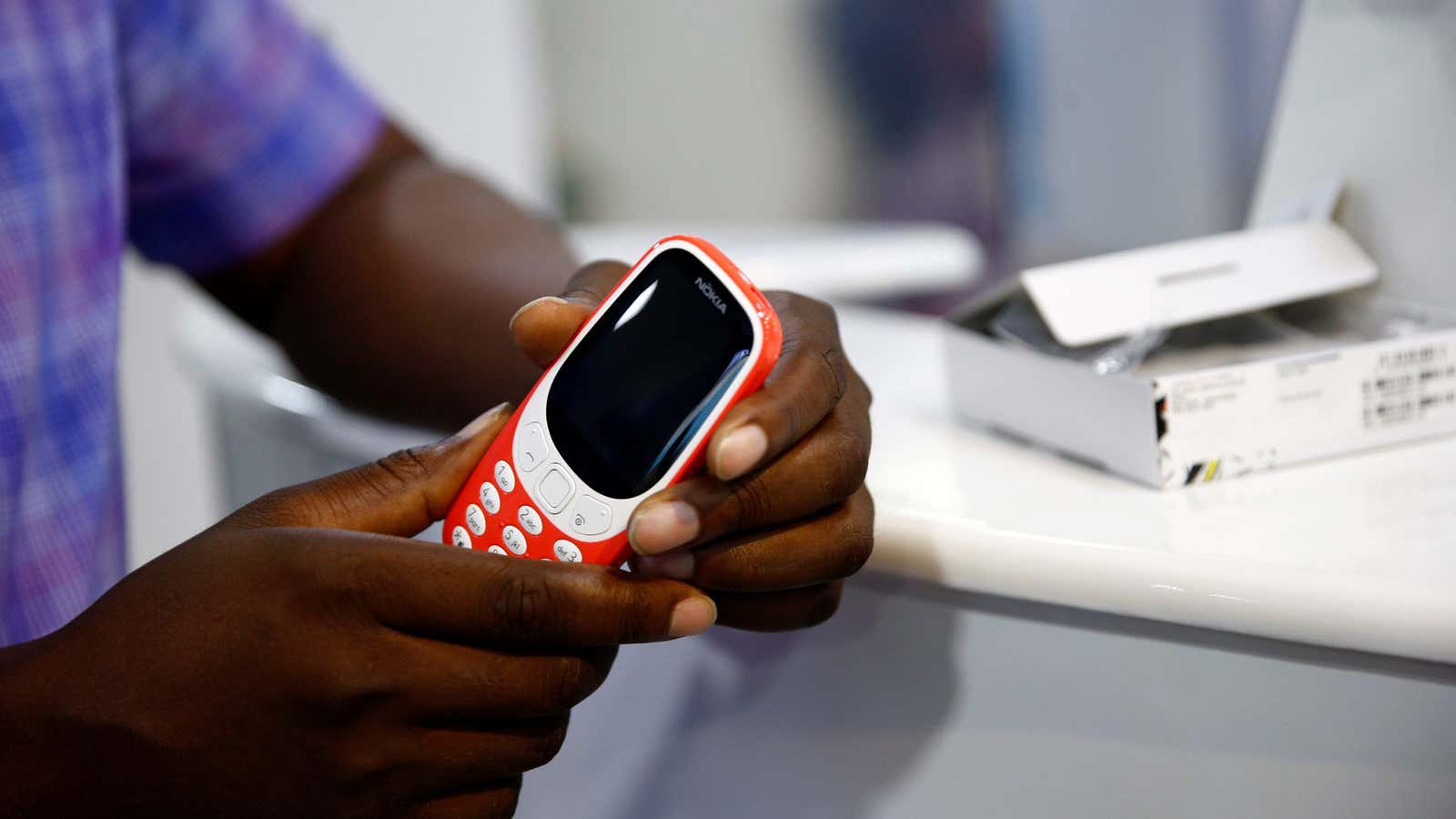 Phone dealer Collins Nwosu holds the new Nokia 3310 model phone in his shop at the ‘Computer Village’ in Ikeja district in Nigeria’s commercial capital…