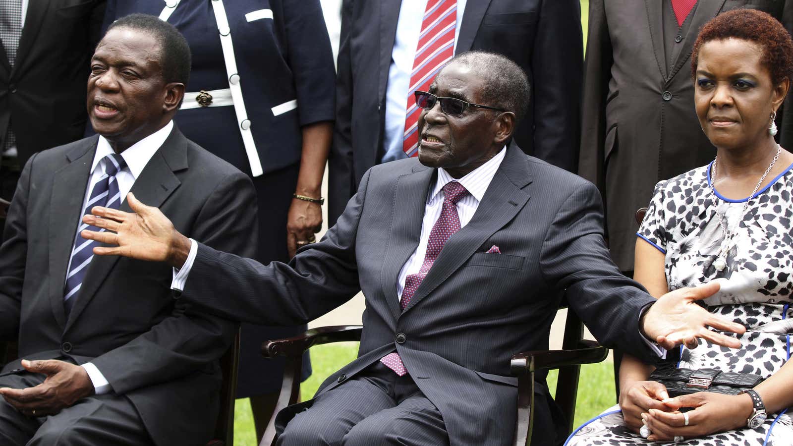 In happier times, perhaps. Zimbabwe’s President Robert Mugabe (C) sits with his wife Grace and Emmerson Mnangagwa (L).