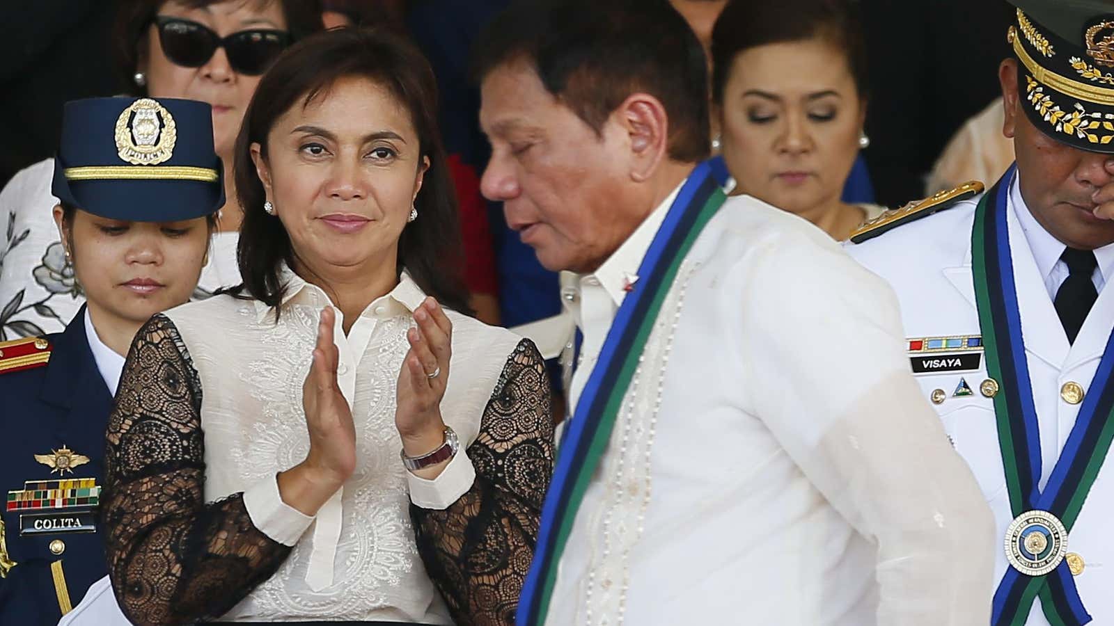 Vice President Leni Robredo applauds as New Philippine President Rodrigo Duterte walks to address the troops during the Change-of-Command ceremony for incoming Armed Forces chief…