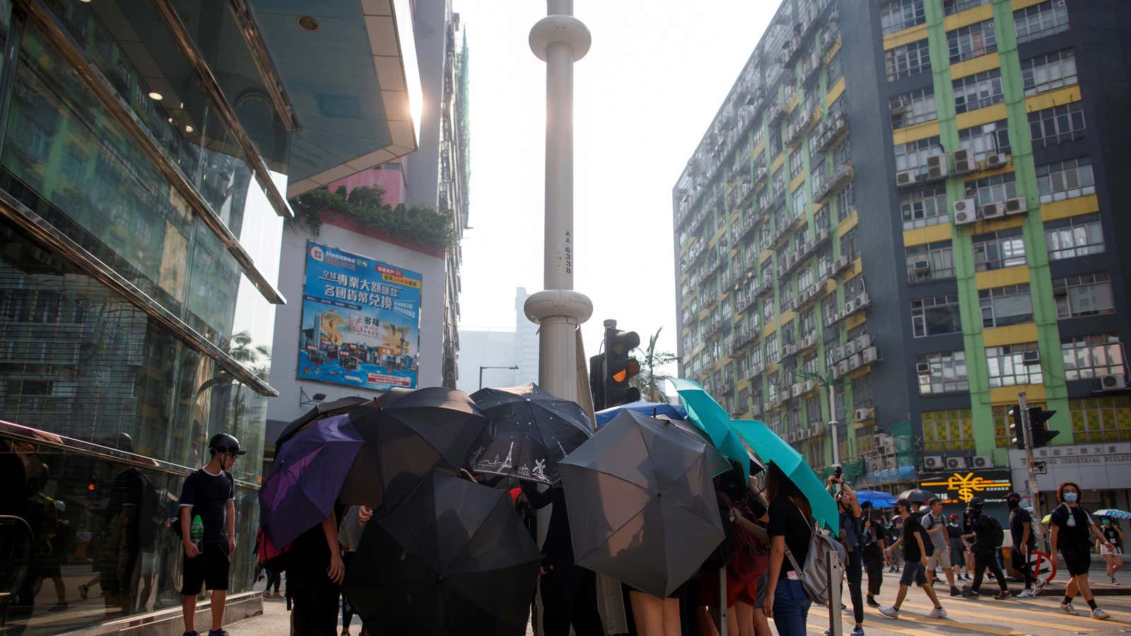 Demonstrators use umbrellas for cover as smart lampposts are damaged in Hong Kong.
