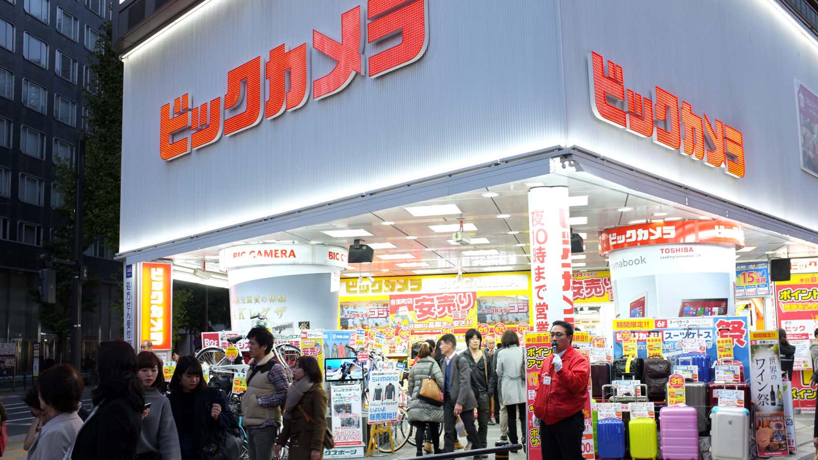 An employee greets shoppers at BIC Camera in Tokyo.