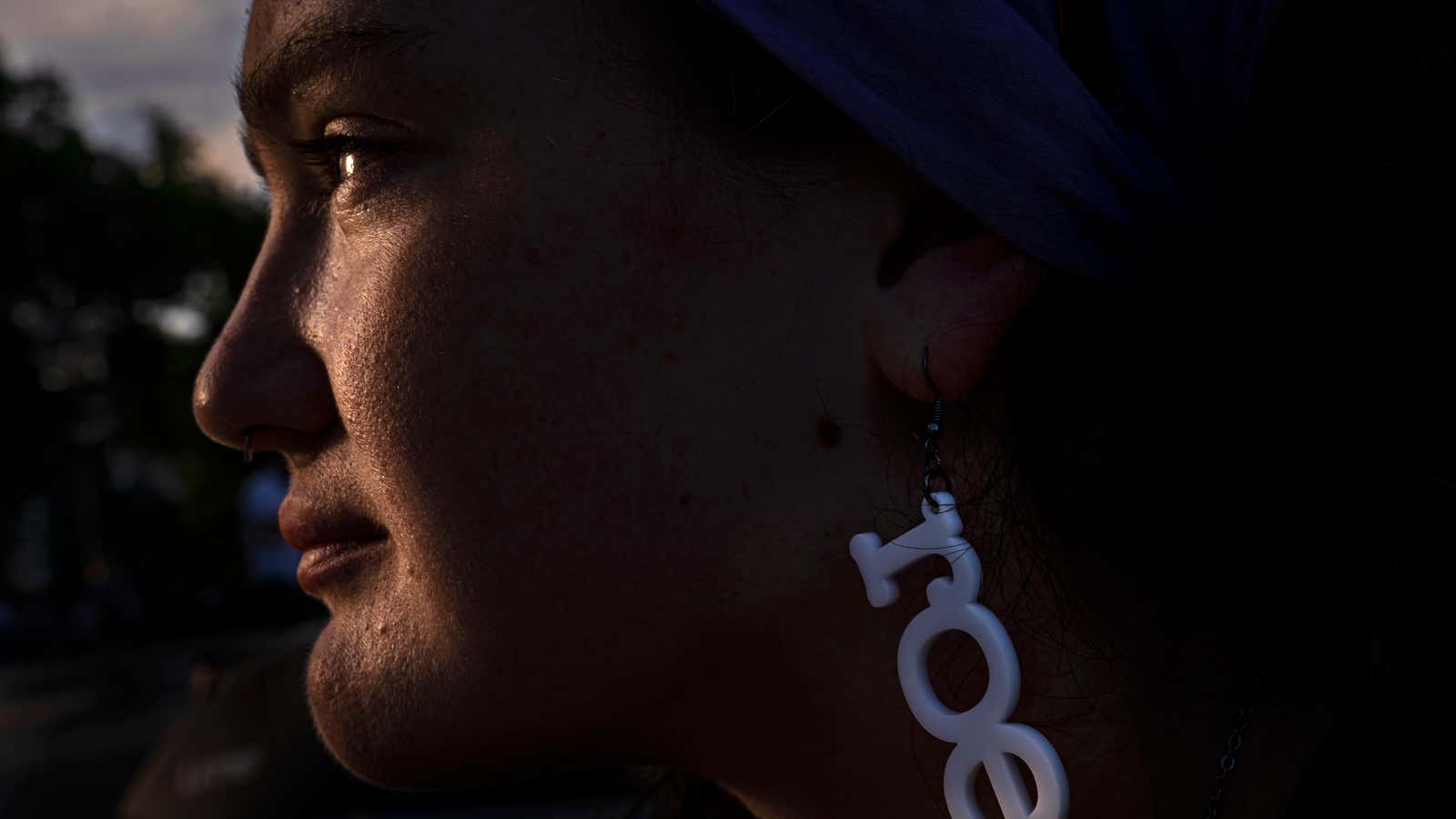 Abortion rights supporter Lilly, who declined to provide a last name, watches the sunset near the Supreme Court on June 28, 2022 in Washington, DC.