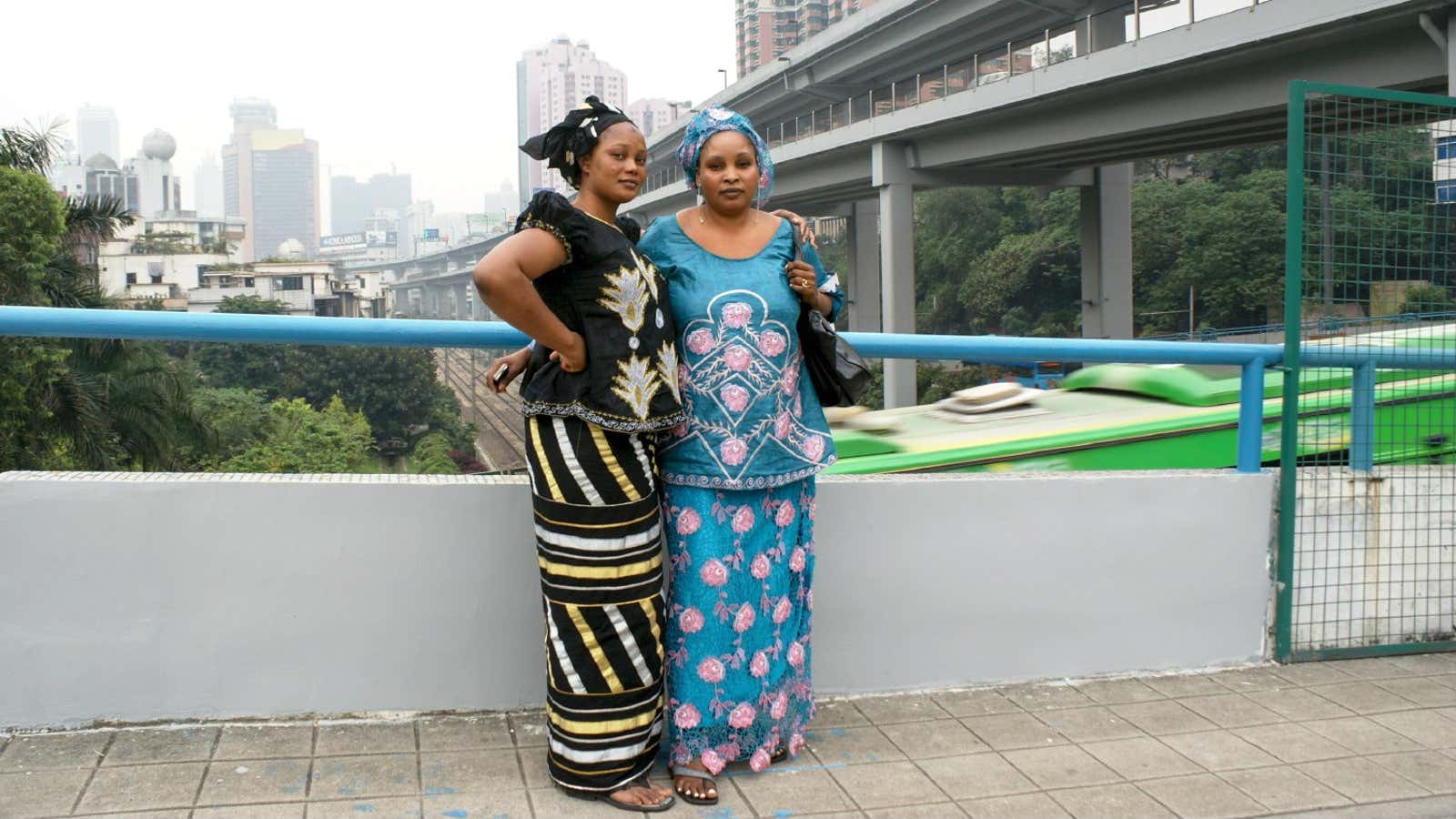 Two women pose for their portrait on a bridge in Guangzhou.