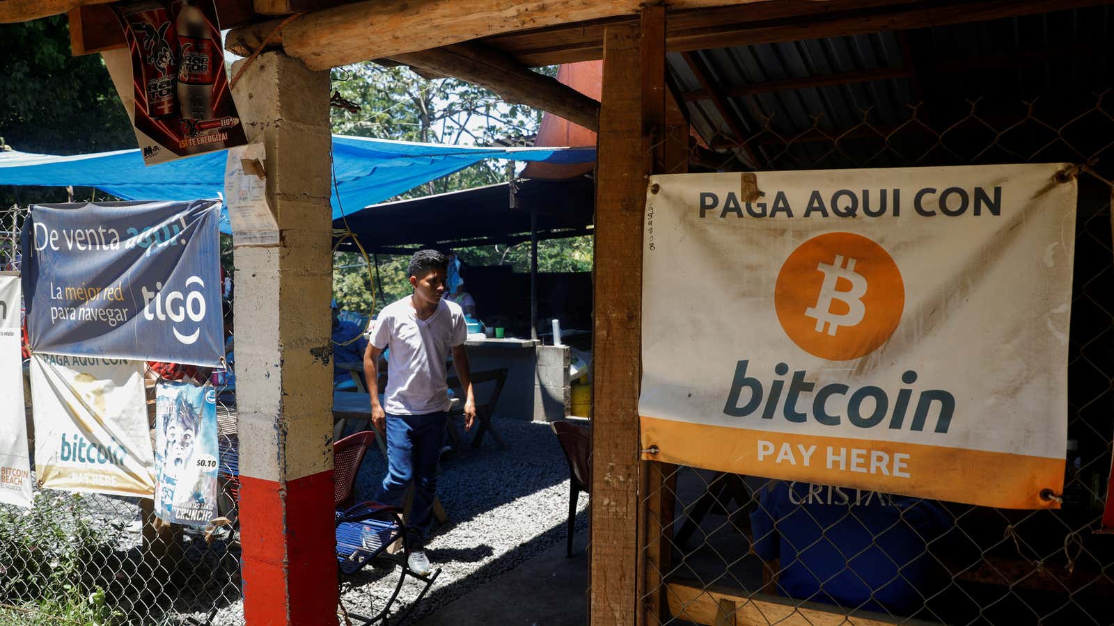 A banner hanging on the exterior wall of a restaurant in El Salvador reads “Pay here with Bitcoin.”