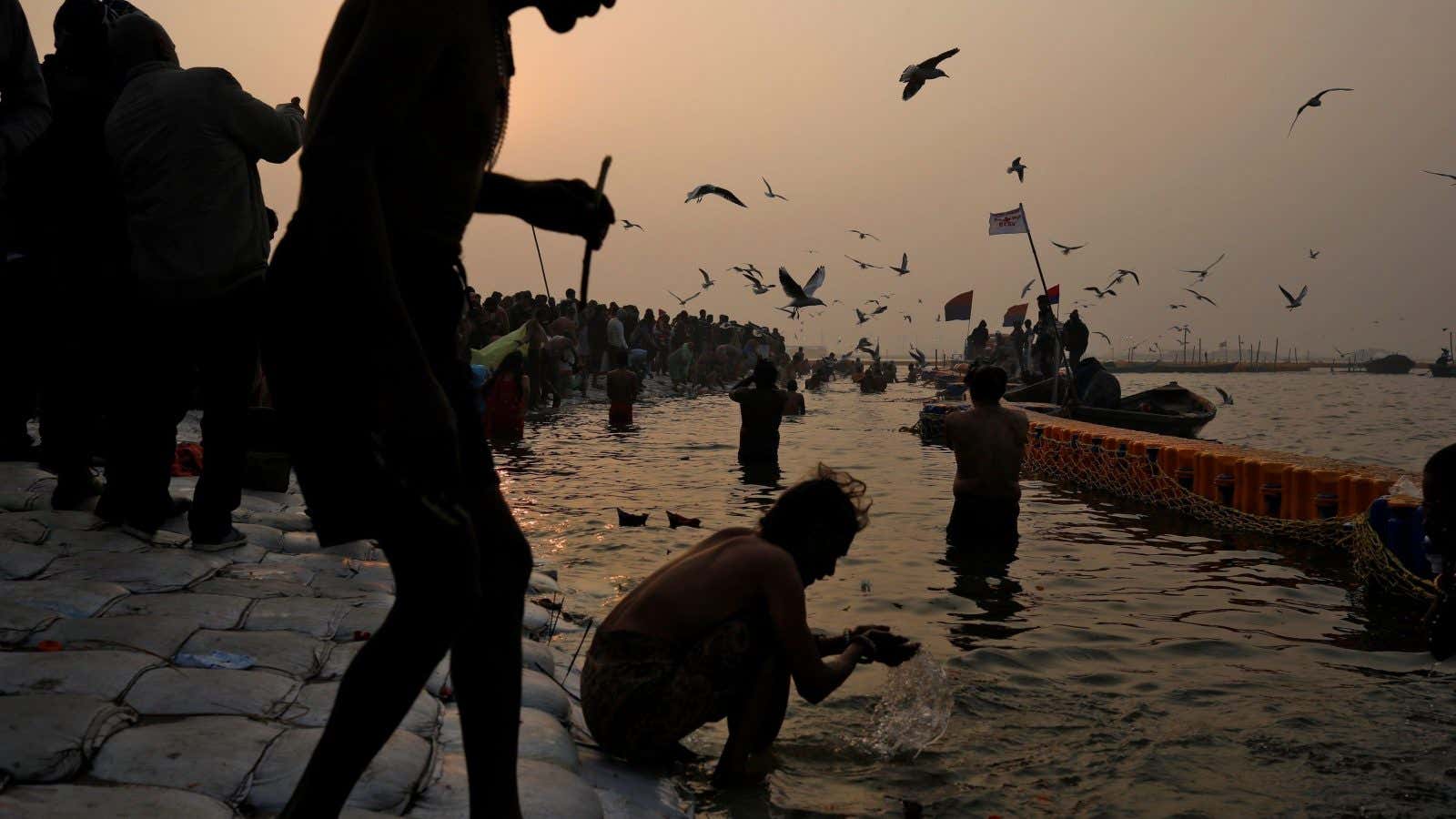 Devotees take a holy dip at Sangam, the confluence of the Ganges, Yamuna and Saraswati rivers, during “Kumbh Mela”, or the Pitcher Festival, in Prayagraj,…