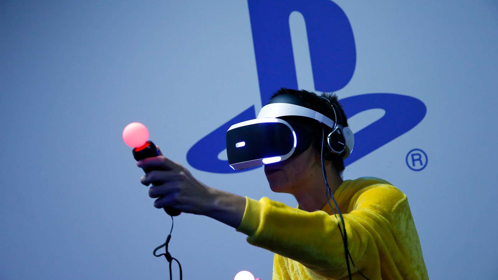 A person plays a game on the original PlayStation VR headset at Paris Games Week in 2015.
