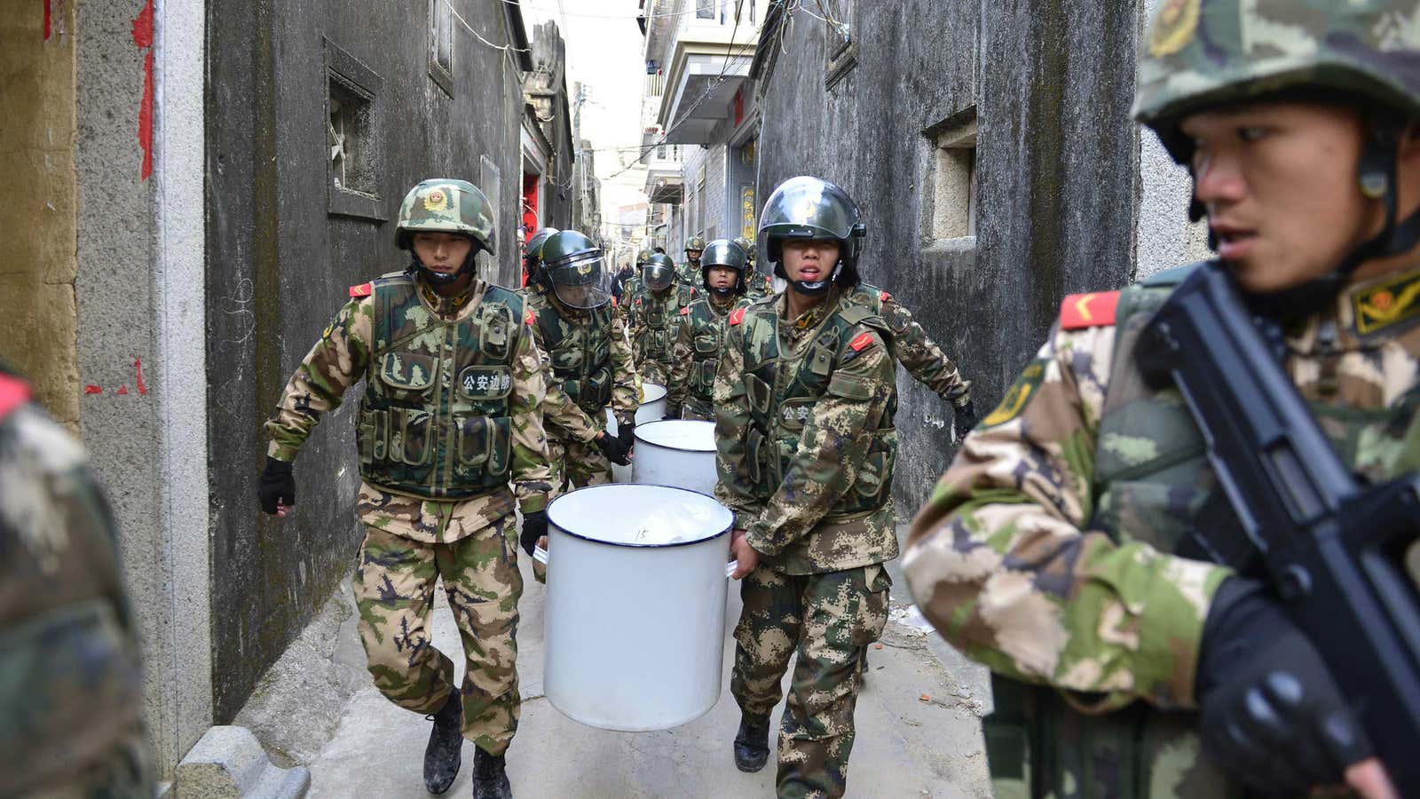 Paramilitary policemen carry seized crystal meth at Boshe village, Lufeng, Guangdong province.