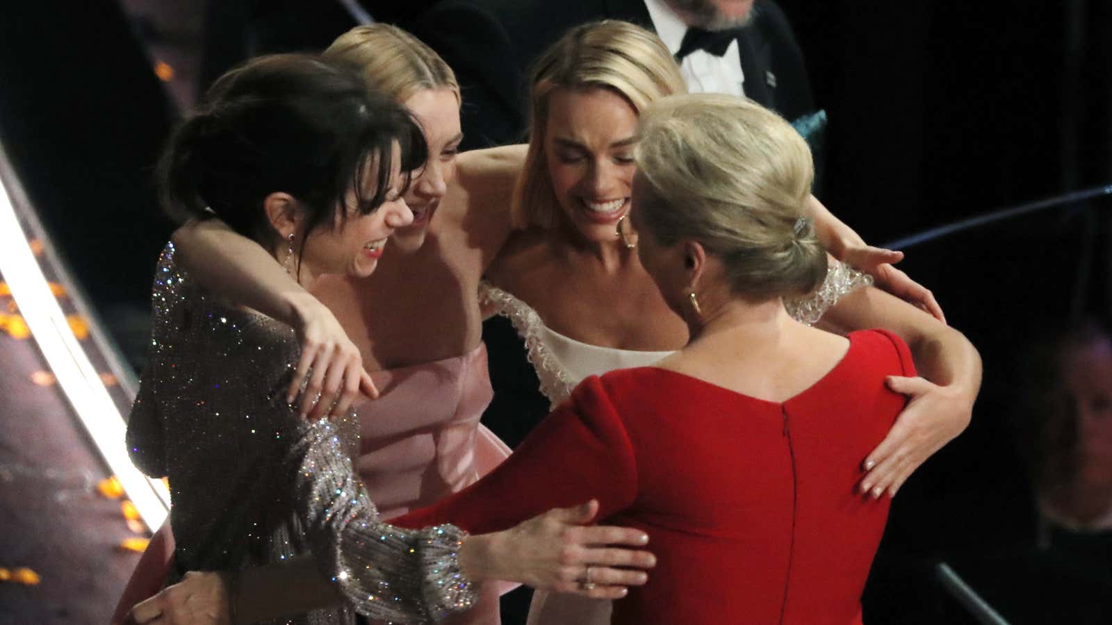 Actresses Sally Hawkins, Saoirse Ronan, Margot Robbie and Meryl Streep embrace.