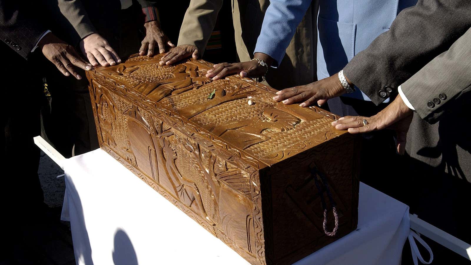 More than 400 caskets containing the remains of slaves were re-burried after they were discovered during building construction in Manhattan.