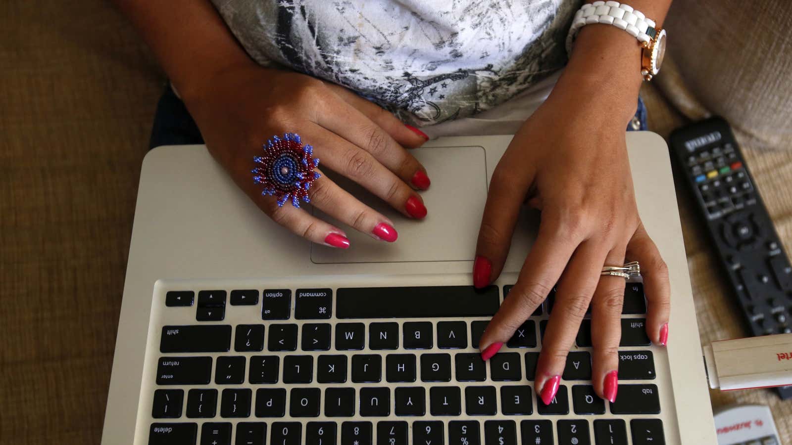 The hands of Malini Agarwal, blogger-in-chief of missmalini.com, are pictured as she blogs from her living room in Mumbai, January 22, 2013. Agarwal, 35, exemplifies…