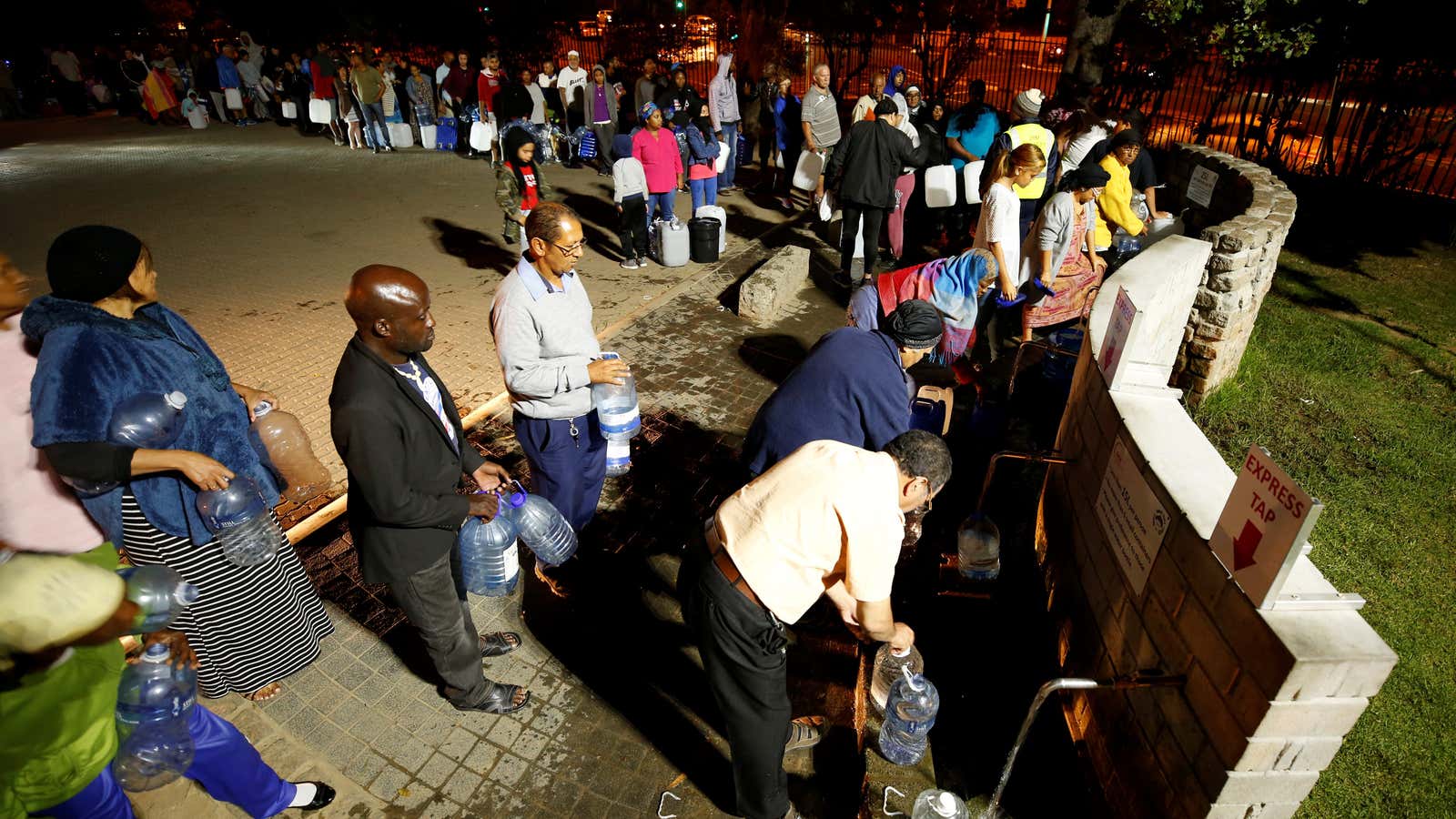 People queue to collect water from a spring in the Newlands suburb of Cape Town