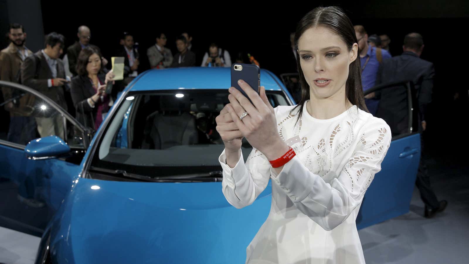 Model Coco Rocha takes a selfie in front of Toyota’s eco-friendly Prius.
