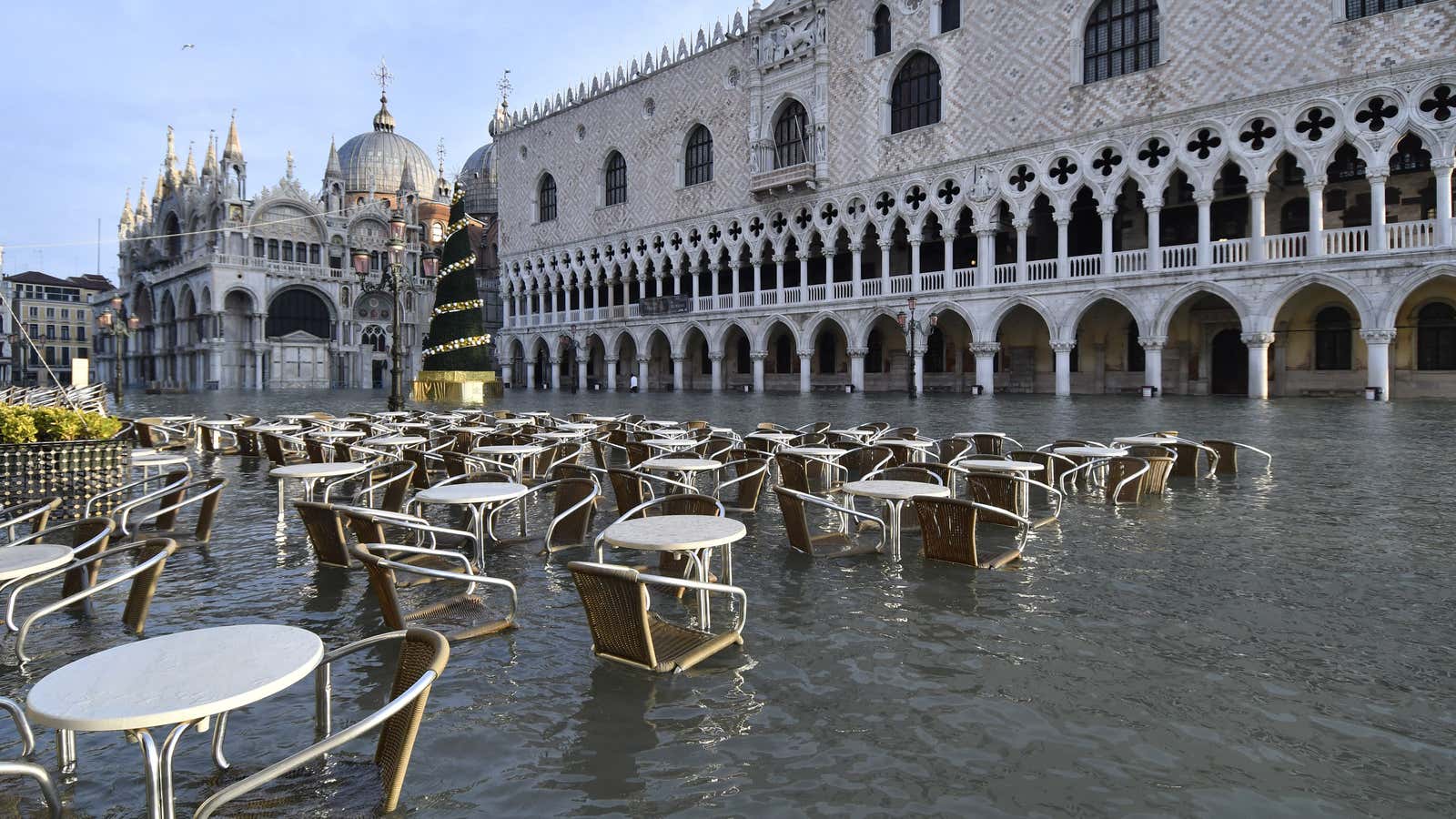 Cafè tables and chairs are partially covered in water during a high tide of 1.44 meters (4.72 feet), in St. Mark’s Square, in Venice, Italy,…