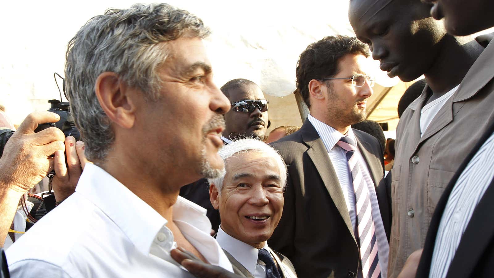 George Clooney makes his way through security to greet Southern Sudan President Salva Kiir after the South Sudan elections in 2011