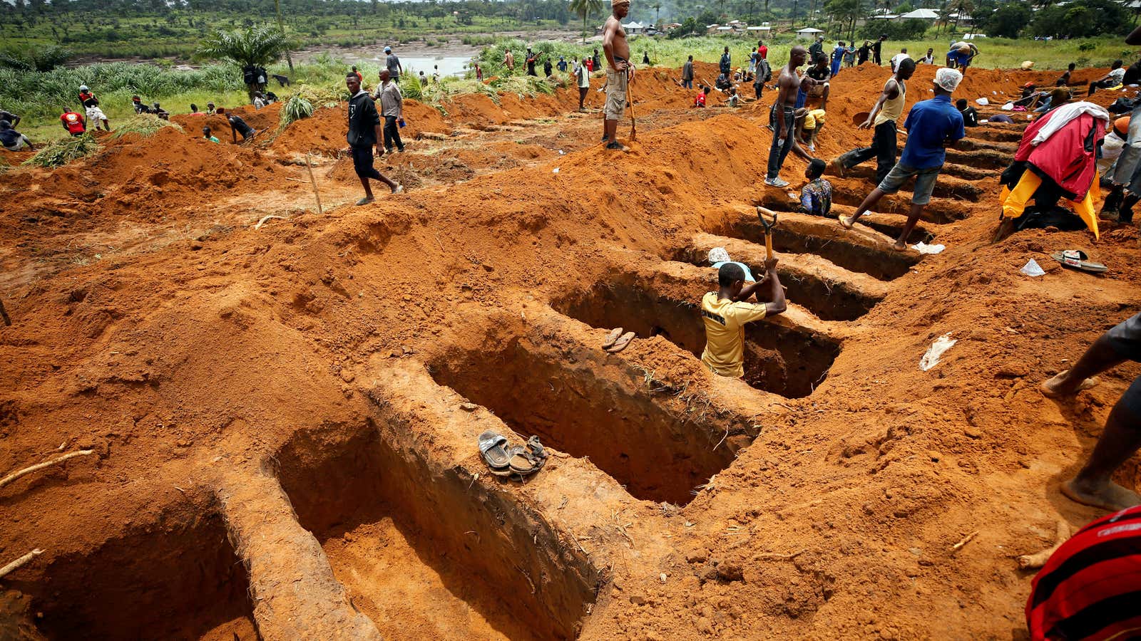 Workers digging mass graves.