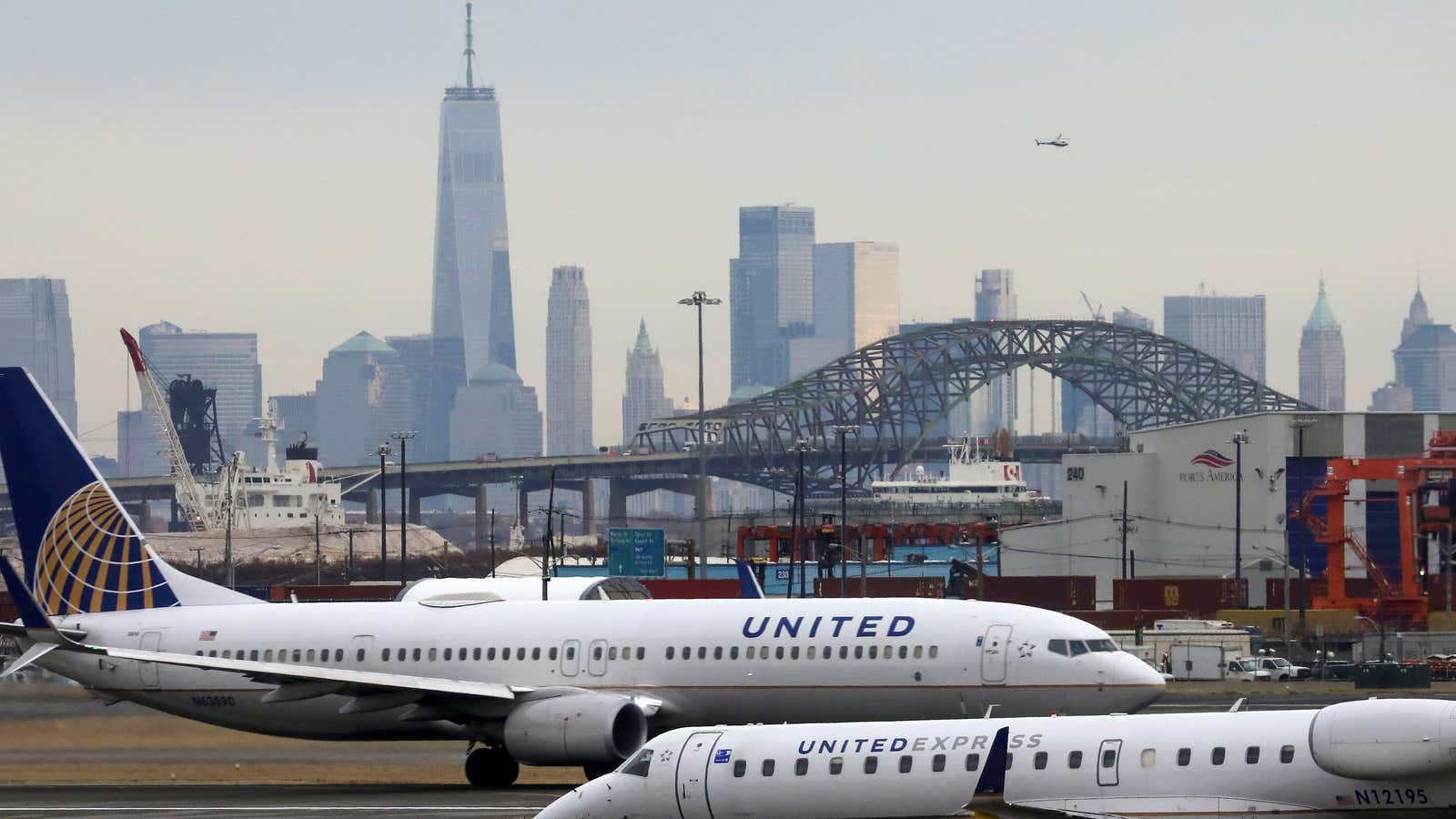 United Airlines passenger jets taxi with New York City as a backdrop, at Newark Liberty International Airport