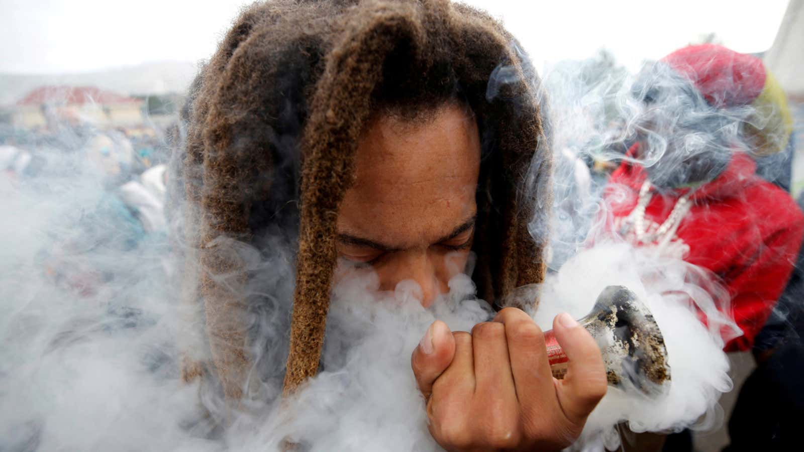 FILE PHOTO: A man smokes marijuana, known locally as dagga, during a march calling for the legalisation of cannabis in Cape Town, South Africa, May…