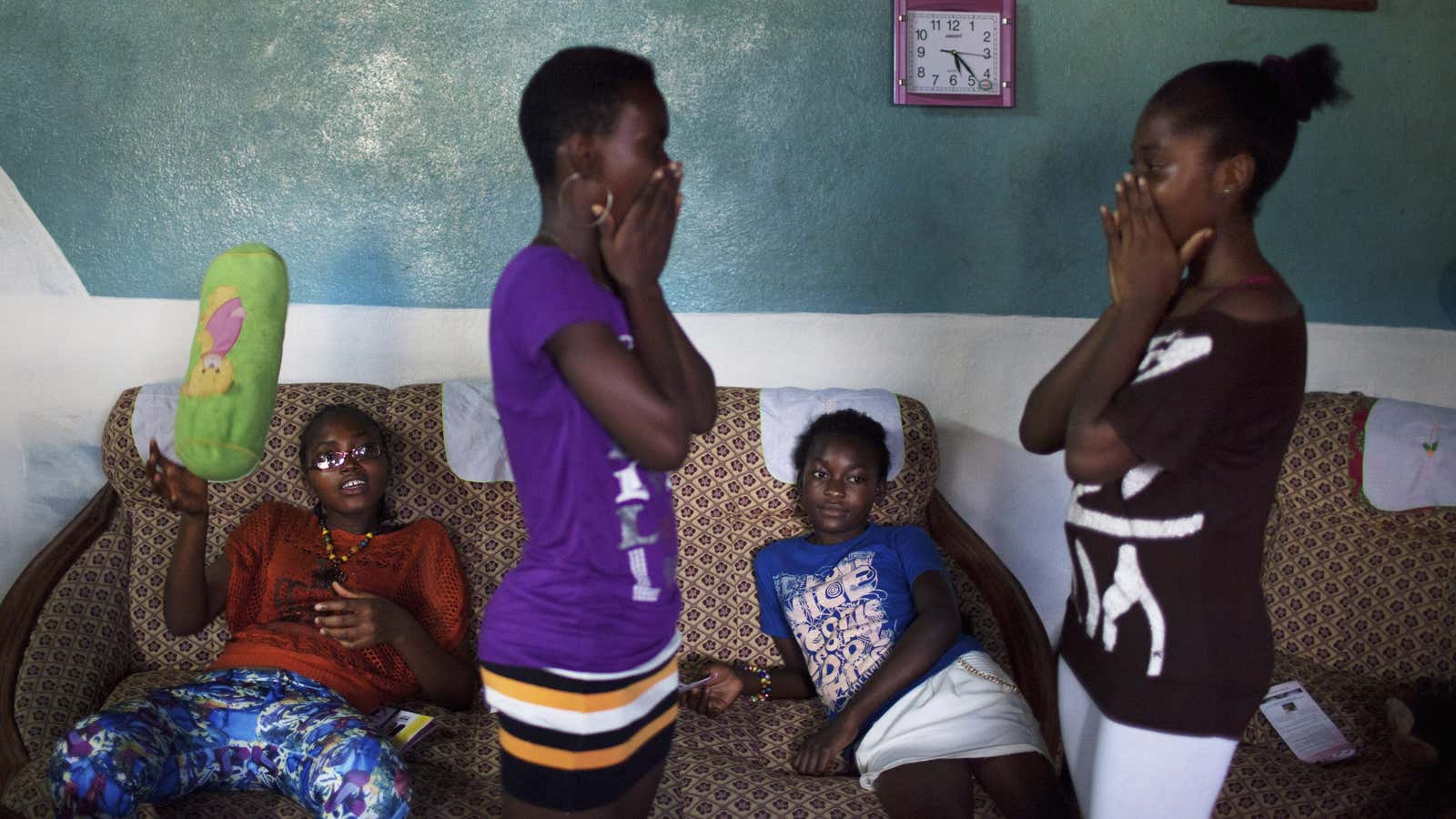 Girls play a clapping game during a weekly education session about breast ironing and rape by a survivor of breast ironing in Douala, Cameroon