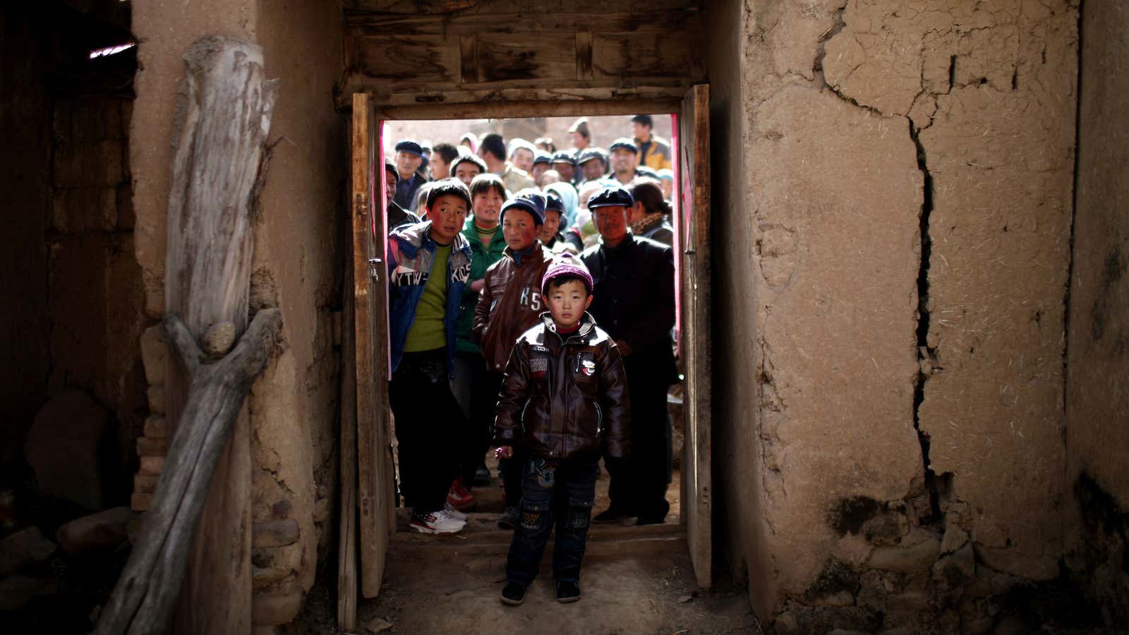 Villagers outside a house in Yuangudui, Gansu Province.