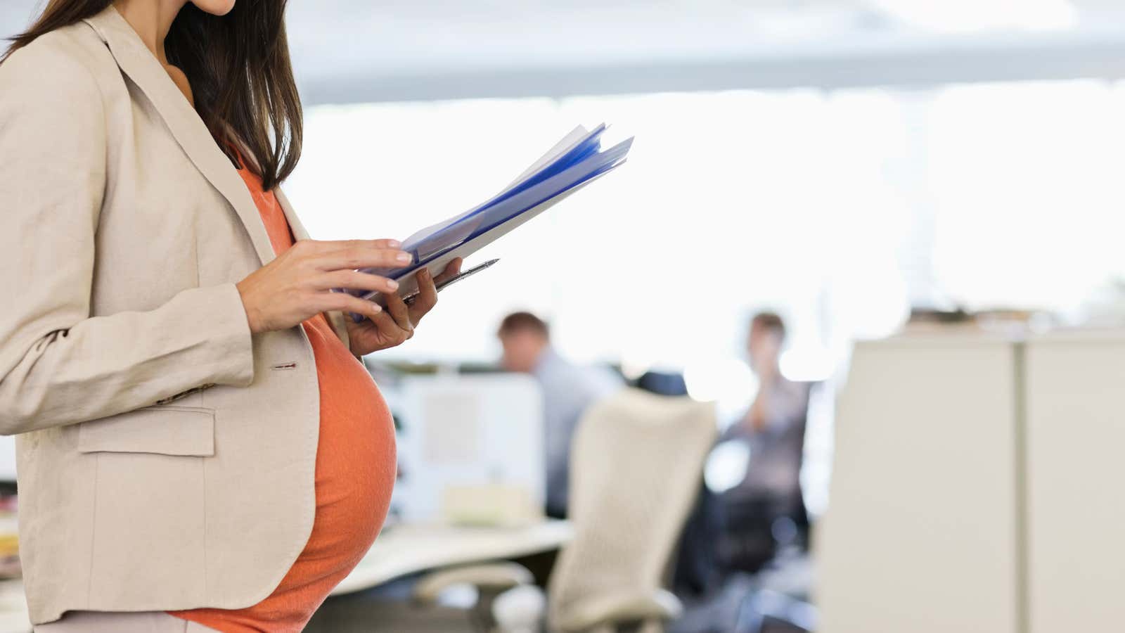Pregnant businesswoman working in office